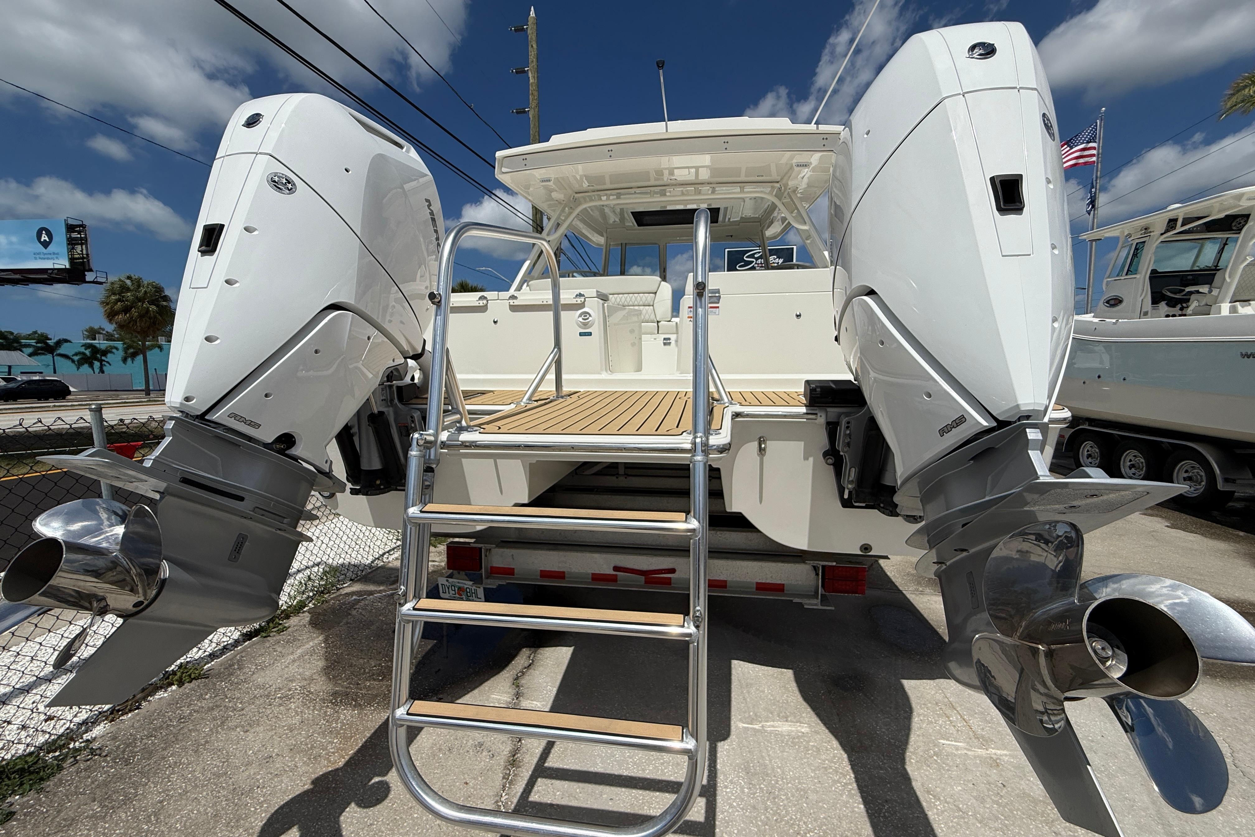 2026 World Cat 400 DC-X Island boat with dual outboard engines and ladder.