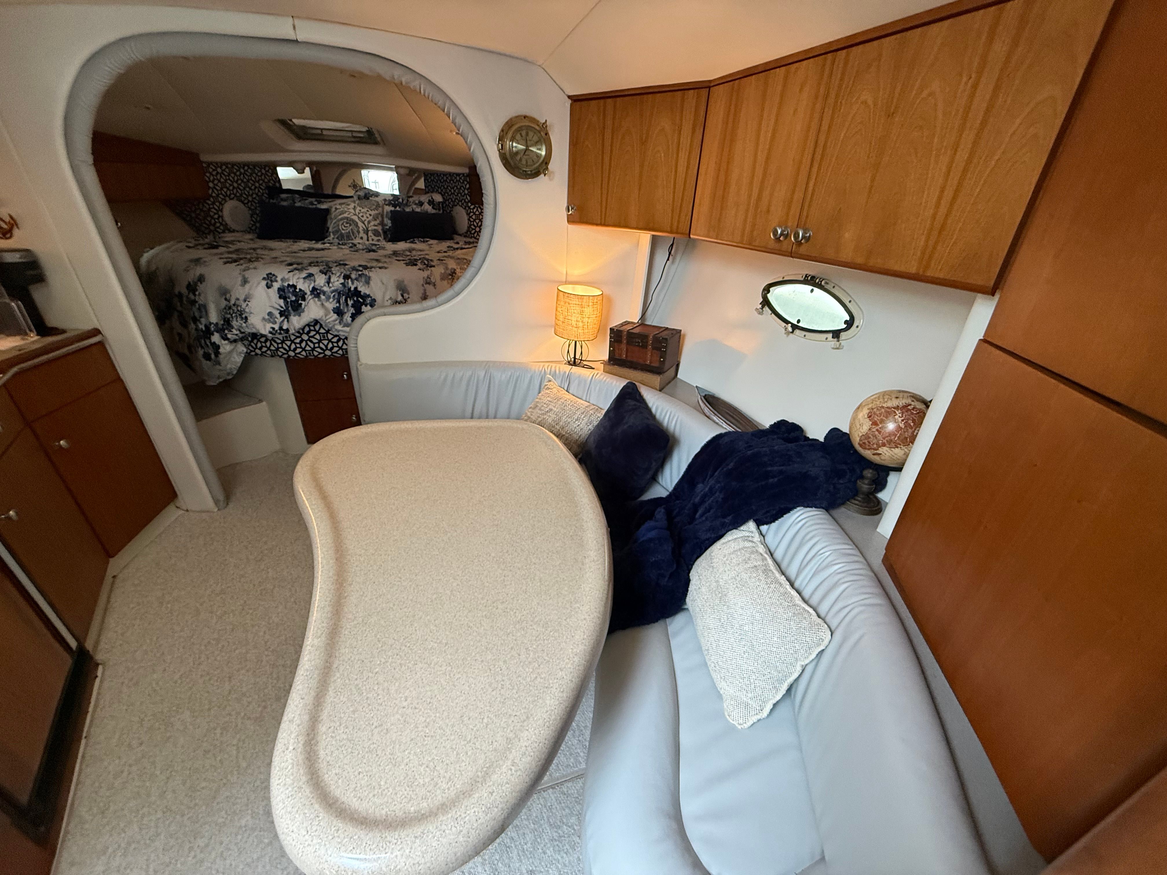 Interior of a 1995 Silverton 360 with cozy seating area and sleeping quarters.