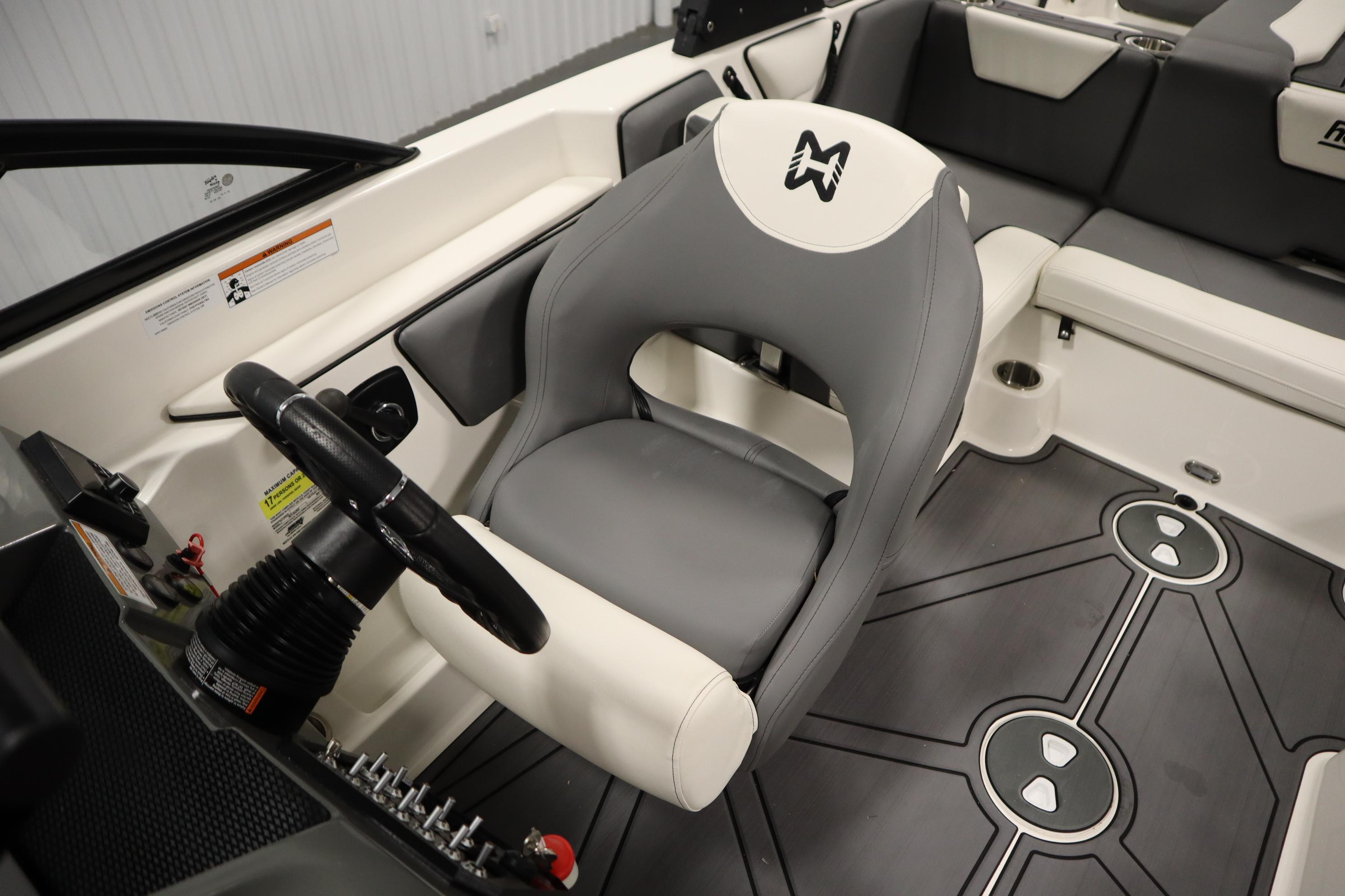 2023 Heyday WT Surf boat interior with steering wheel and seating.