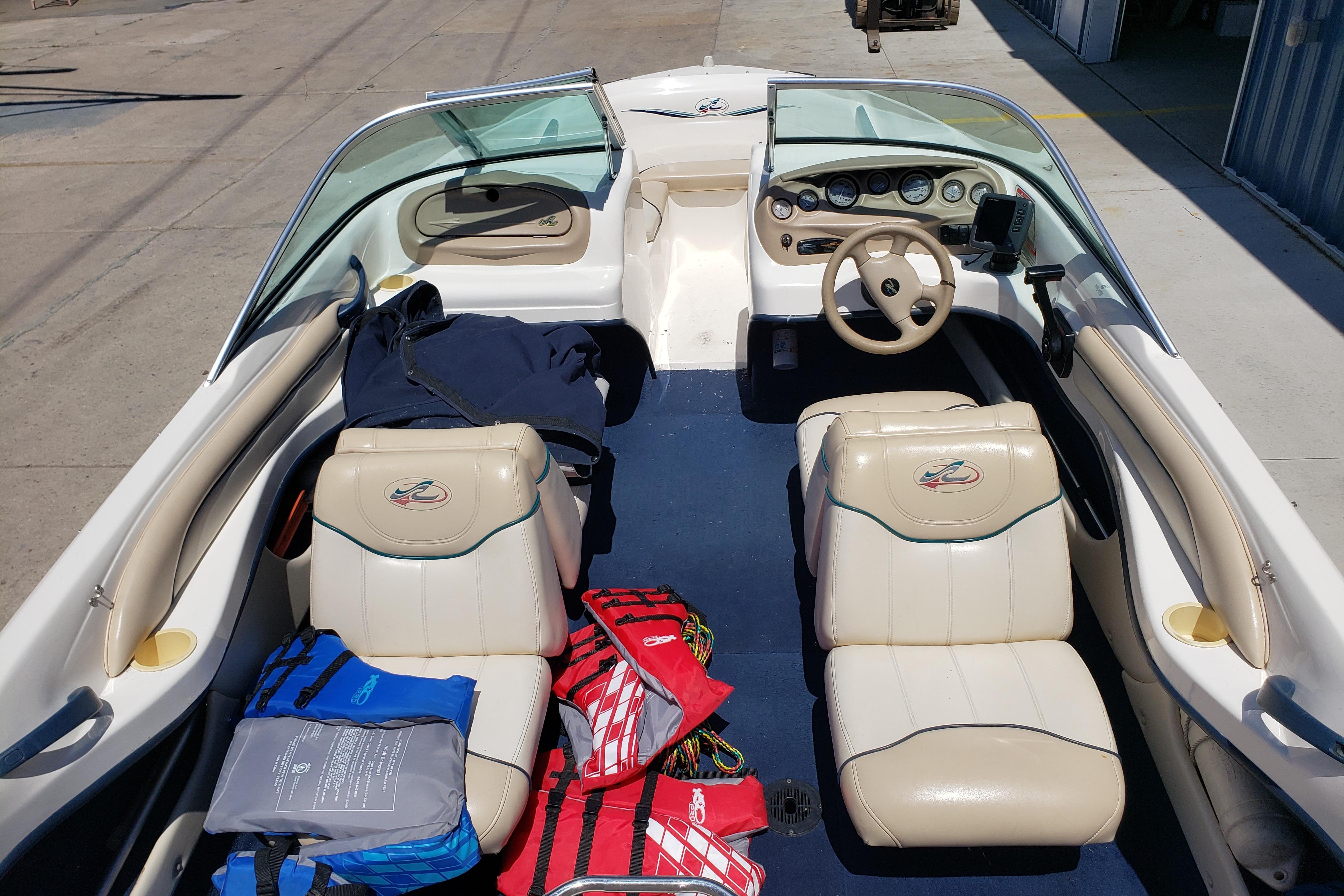 1998 Sea Ray 180 Bow Rider interior with life jackets and steering wheel visible.