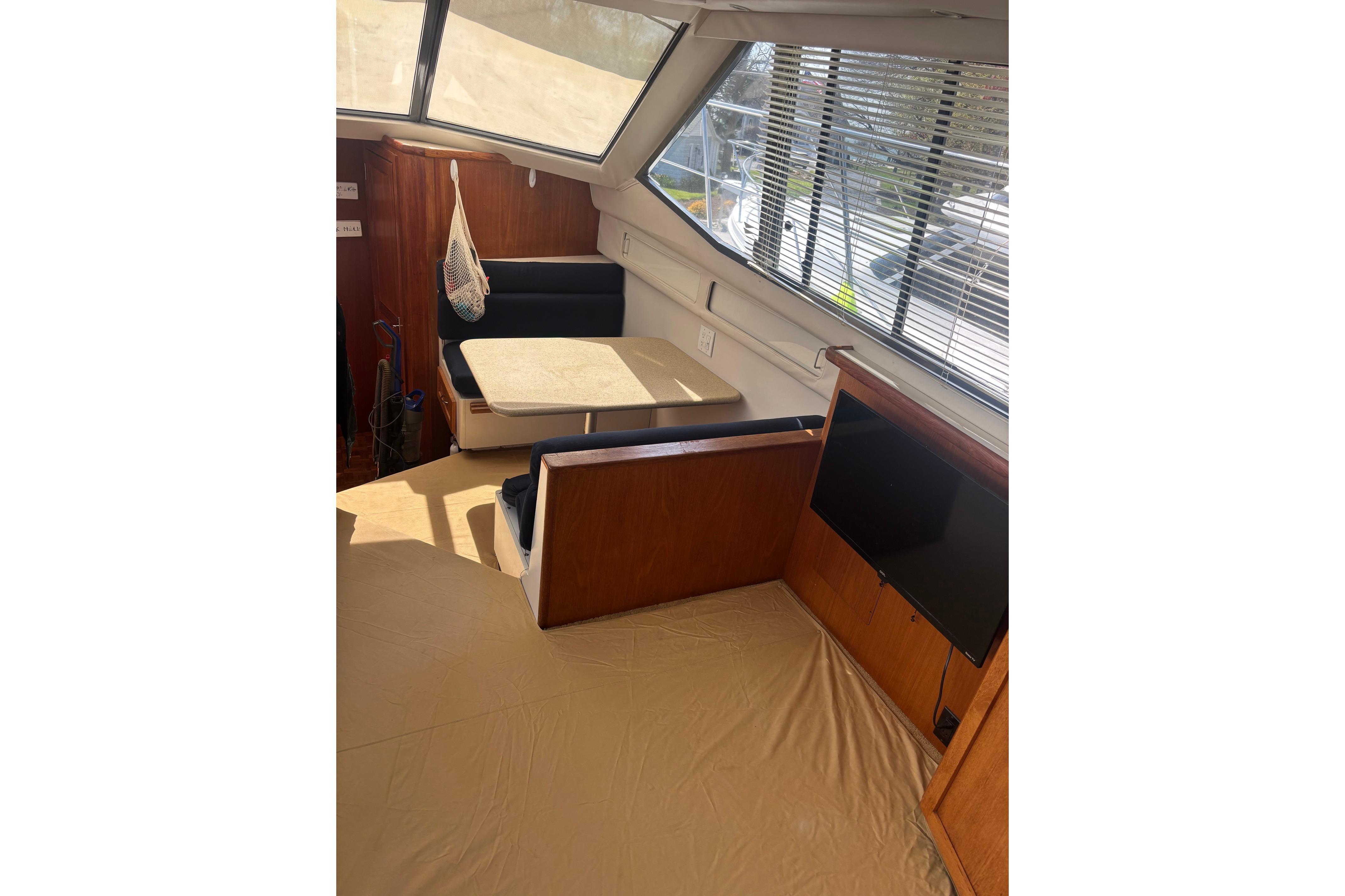 Interior of 1995 Carver 356 Aft Cabin Motor Yacht with dining area and windows.