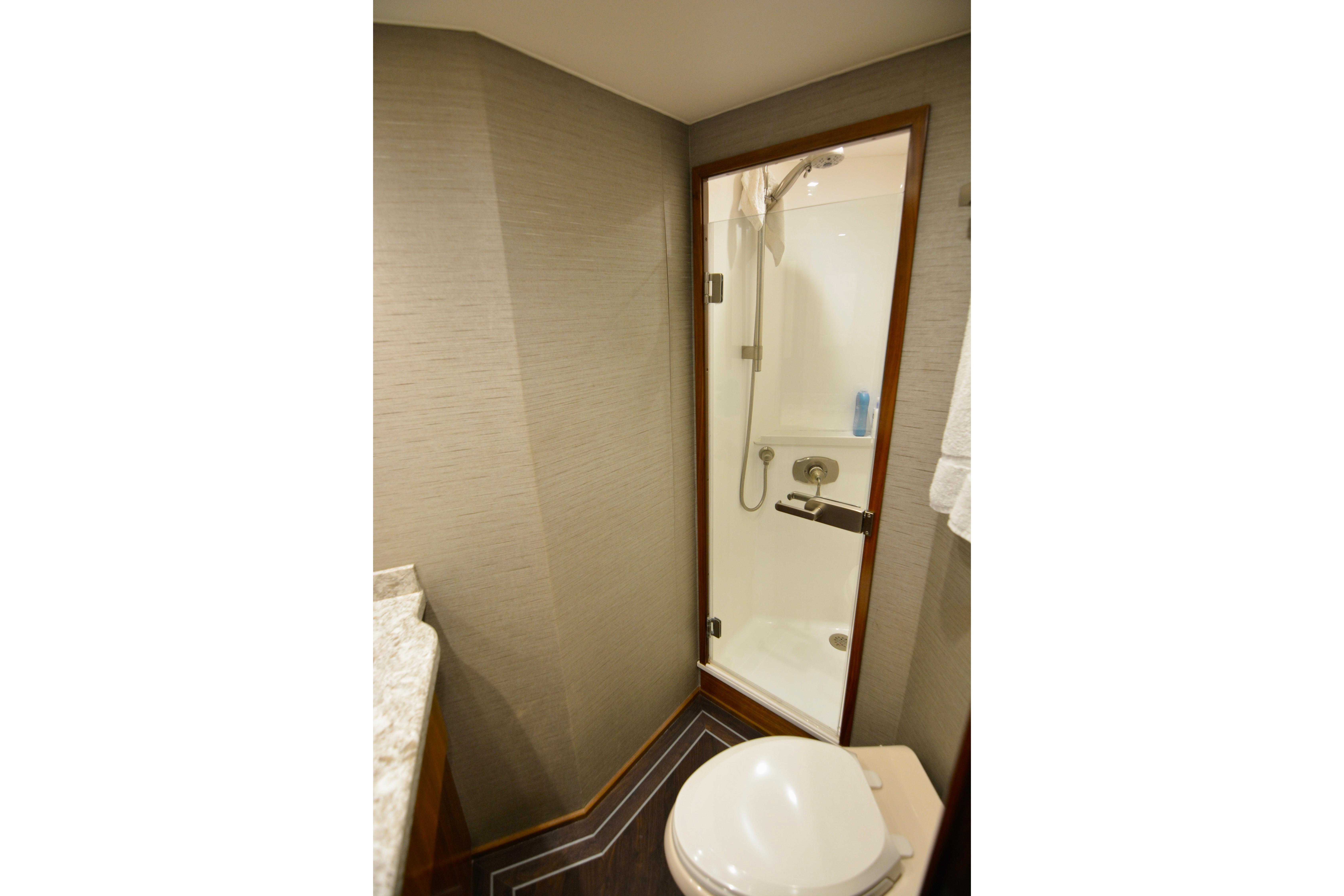Bathroom interior of 2019 Viking 68 Convertible yacht with shower and toilet.