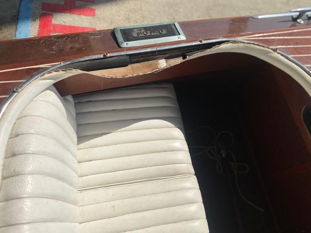 Grand Craft Classic Runabout 2000 with white leather seat and wooden trim detail.
