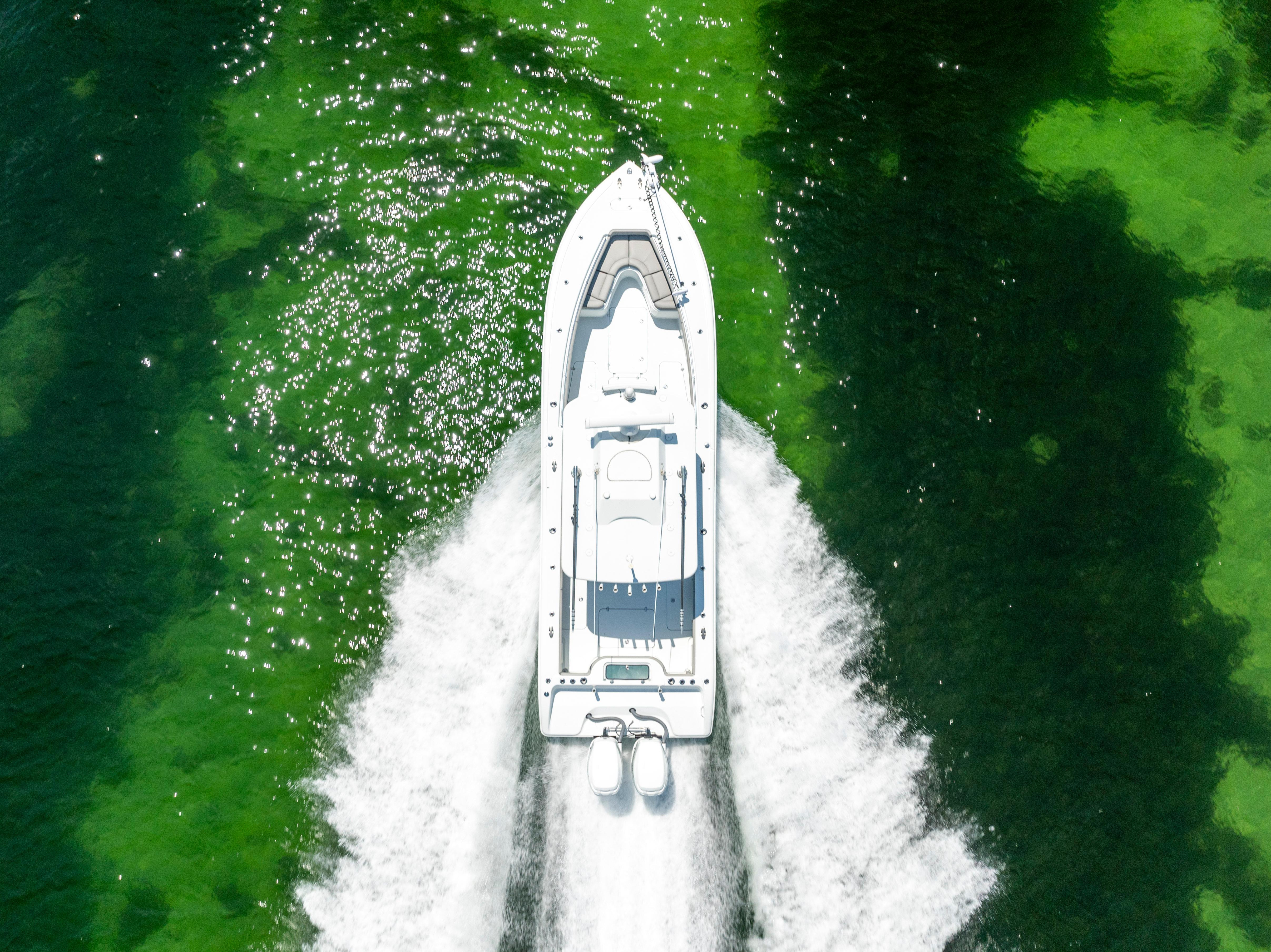 Aerial view of 2018 Yellowfin 32 Offshore boat on green water.