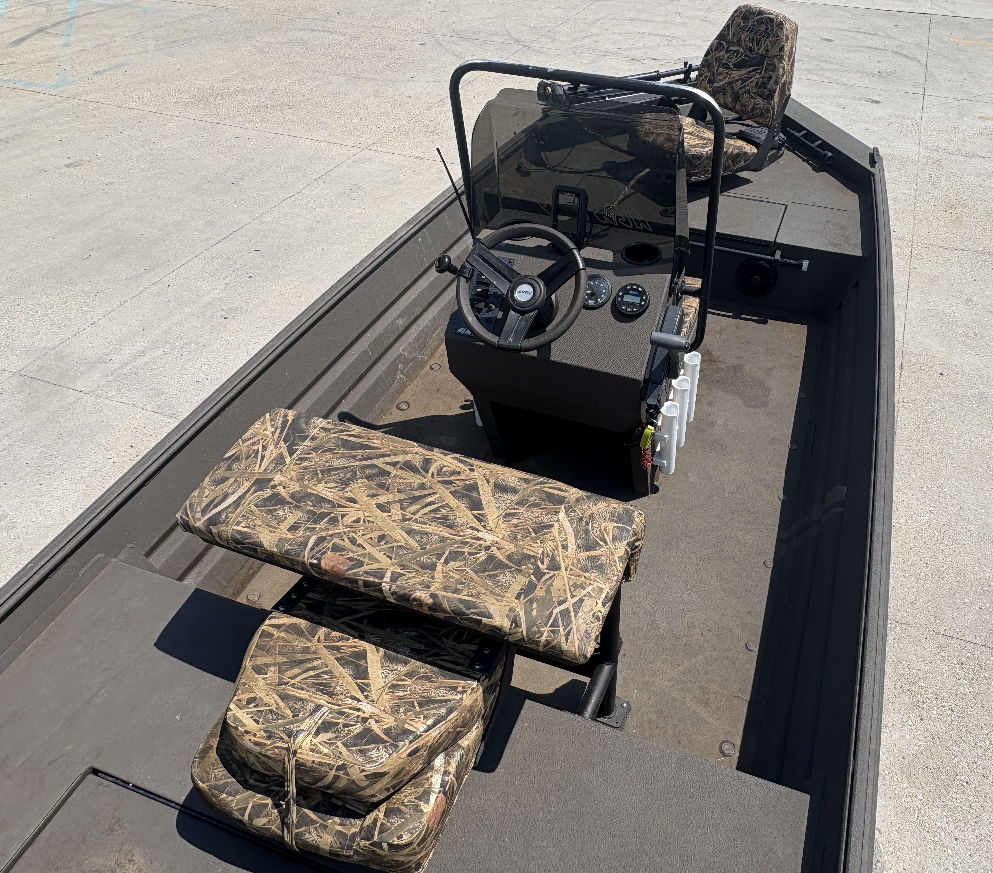2023 Alweld 16x52 Marsh boat interior with camouflage seating and steering console.