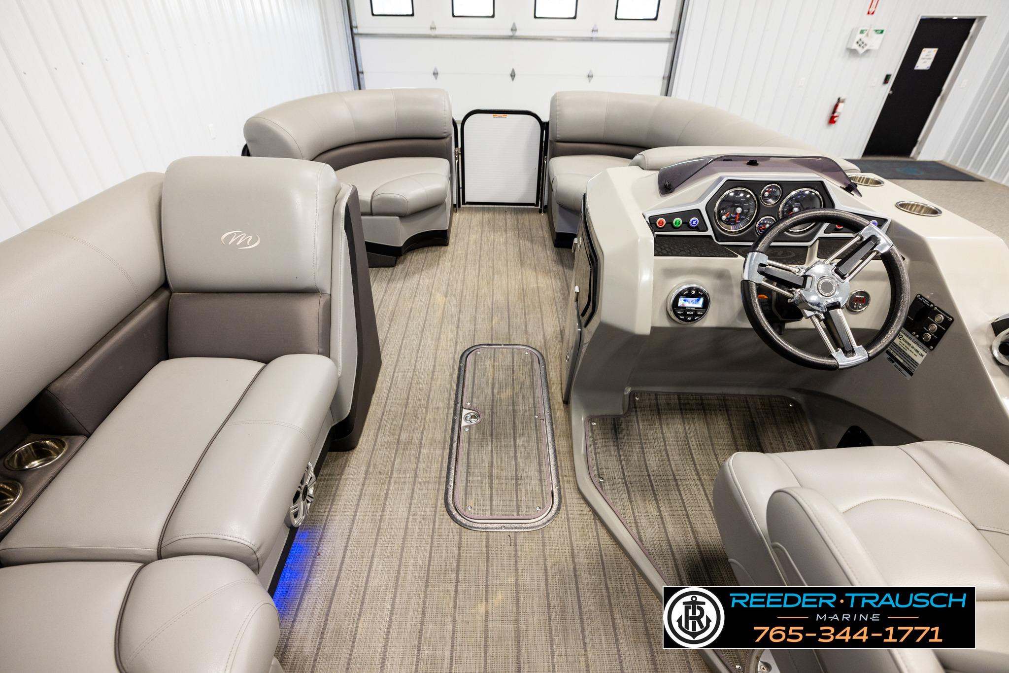 Interior view of 2019 Manitou Oasis SR VP pontoon boat with plush seating and modern dashboard.