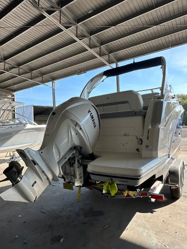 2025 Regal 26XO boat with Yamaha outboard engine in covered storage.