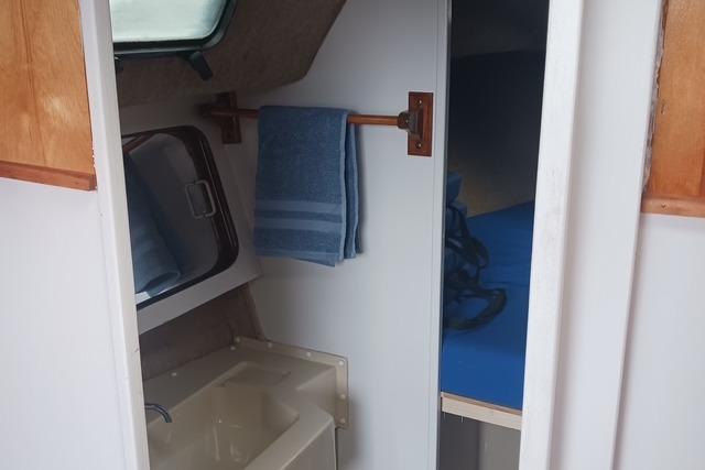 1989 O'Day 272 sailboat interior with sink, towel, and cabin view.