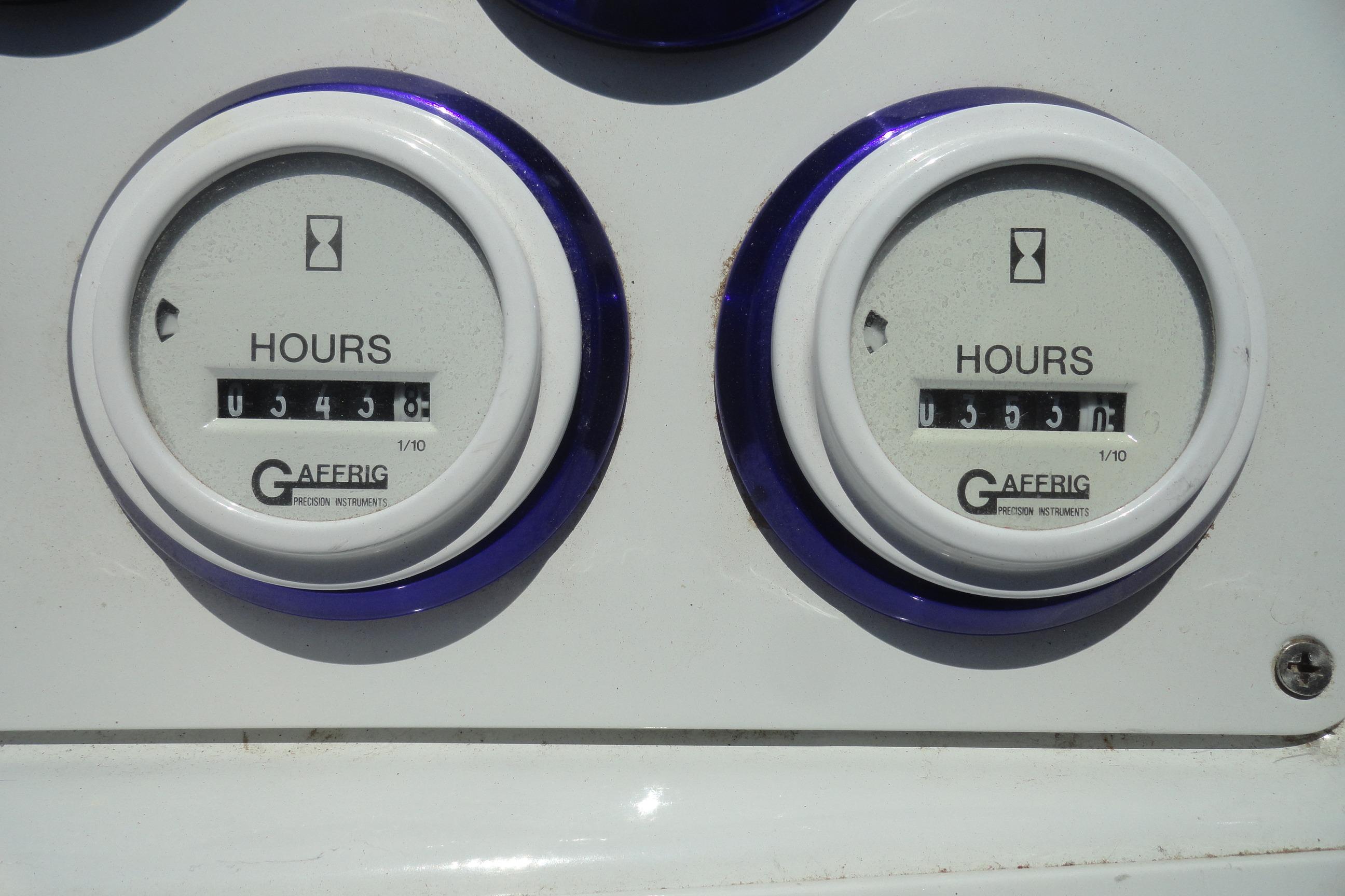 Hour meters on a 1988 Wellcraft 34 Scarab boat dashboard, showing usage hours.