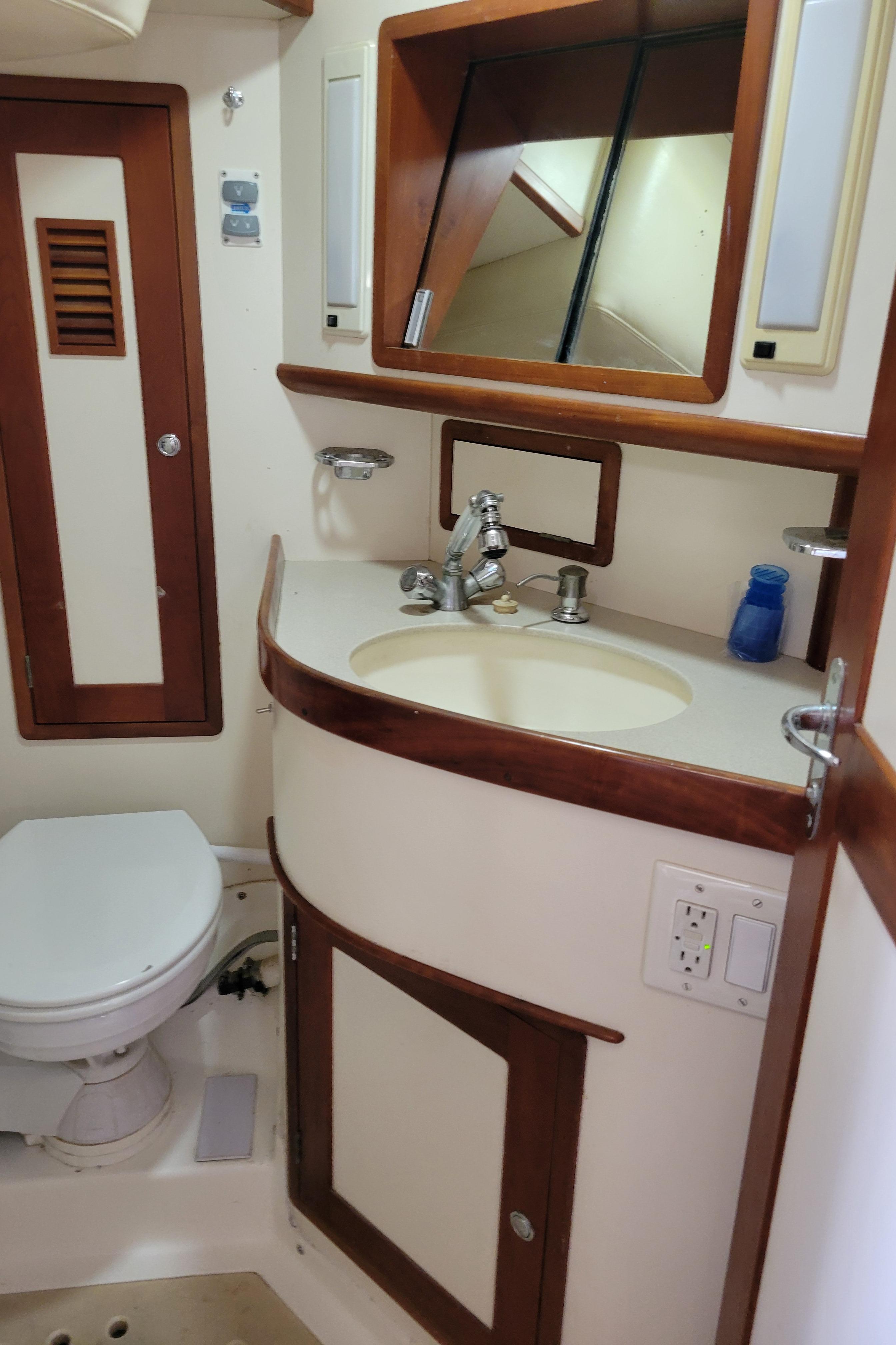 Bathroom interior of 1996 Little Harbor 51 Pilothouse yacht, featuring sink and toilet.