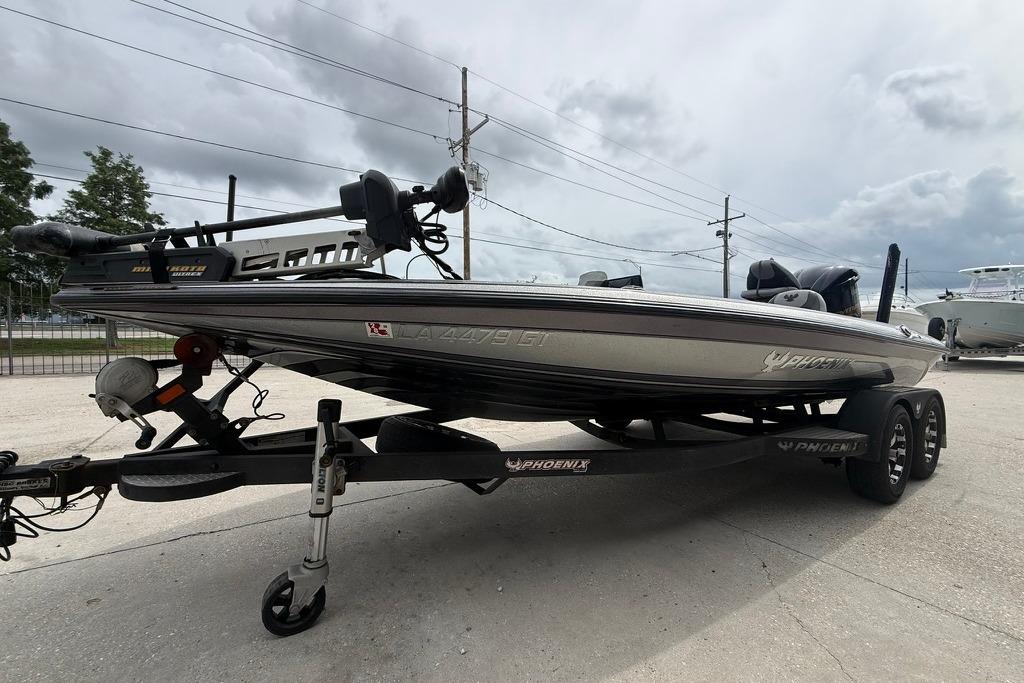 2018 Phoenix 919 ProXP boat on trailer, parked outdoors under cloudy sky.