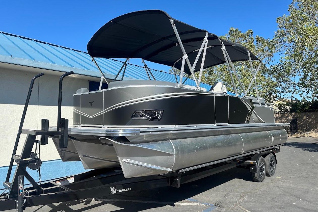 2026 Tahoe Pontoon LTZ Quad Lounger Shift 23 on trailer, featuring sleek design and canopy.