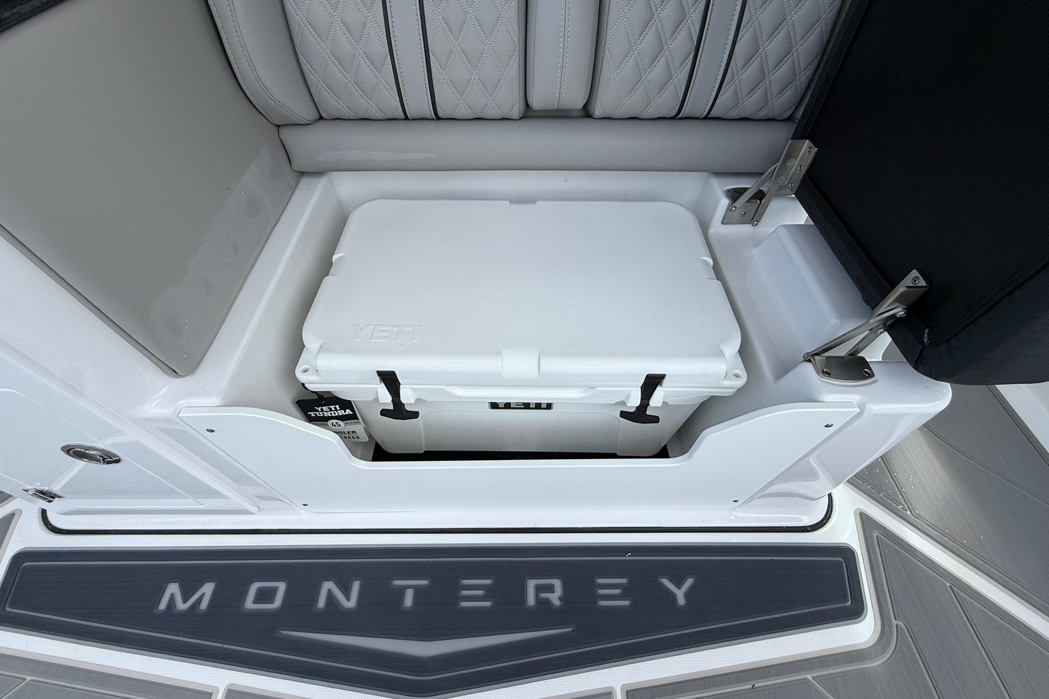 2027 Monterey Elite 30 OB boat interior with Yeti cooler storage compartment.