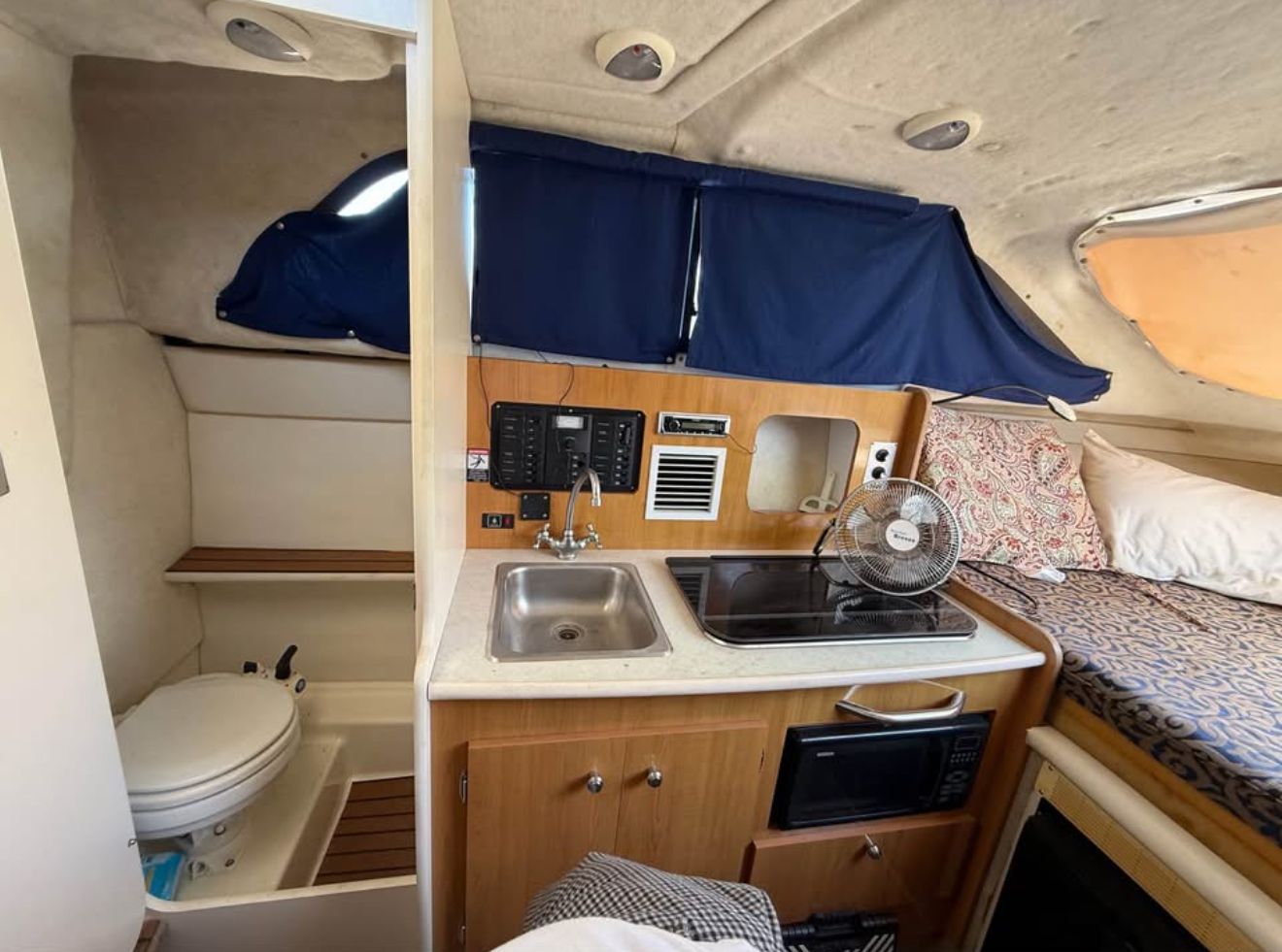 Interior of a 2003 Bayliner 2452 Classic Cruiser with kitchen and sleeping area.