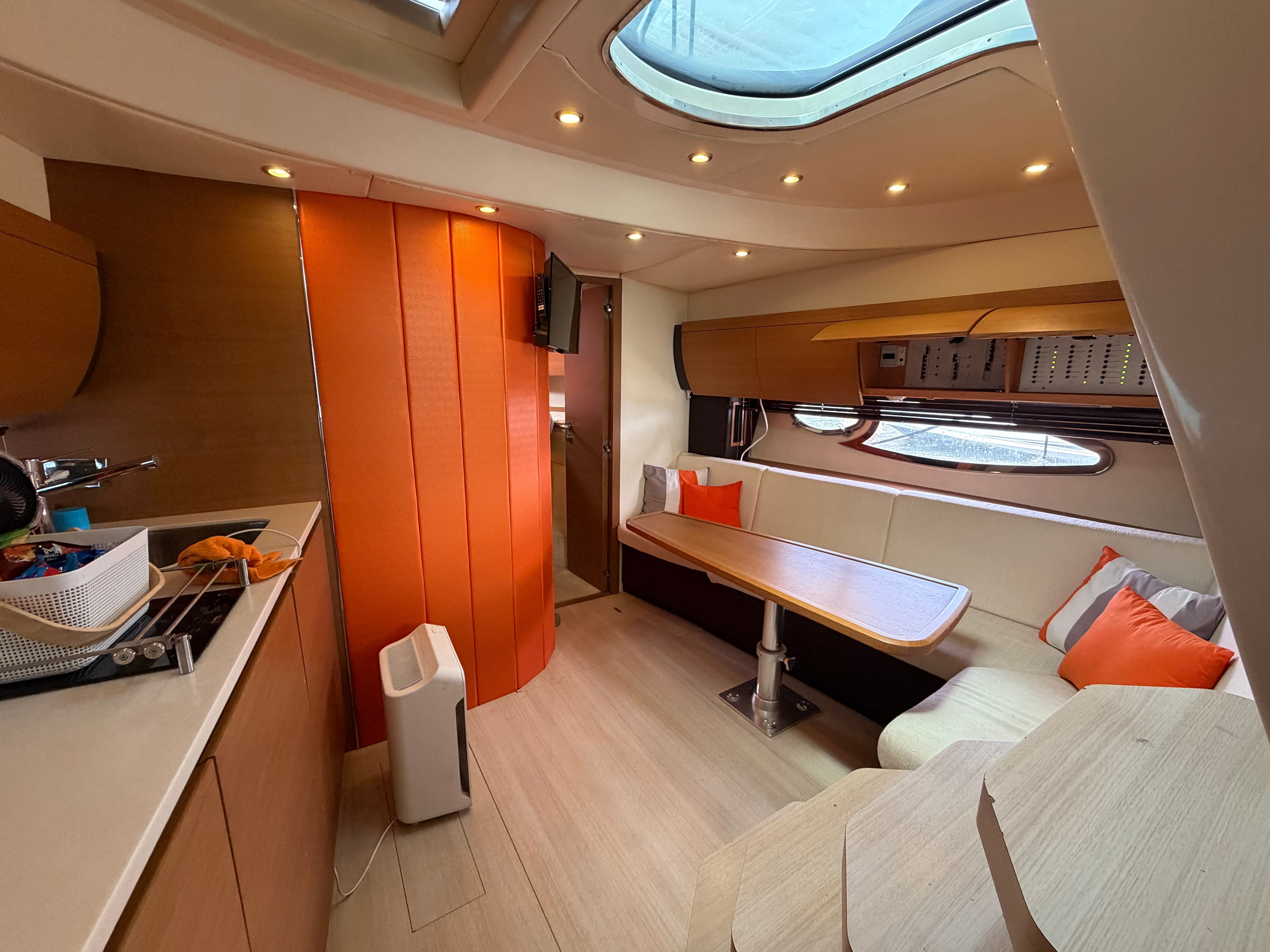Interior of the 2011 Azimut Atlantis 40 with modern amenities and a cozy seating area.