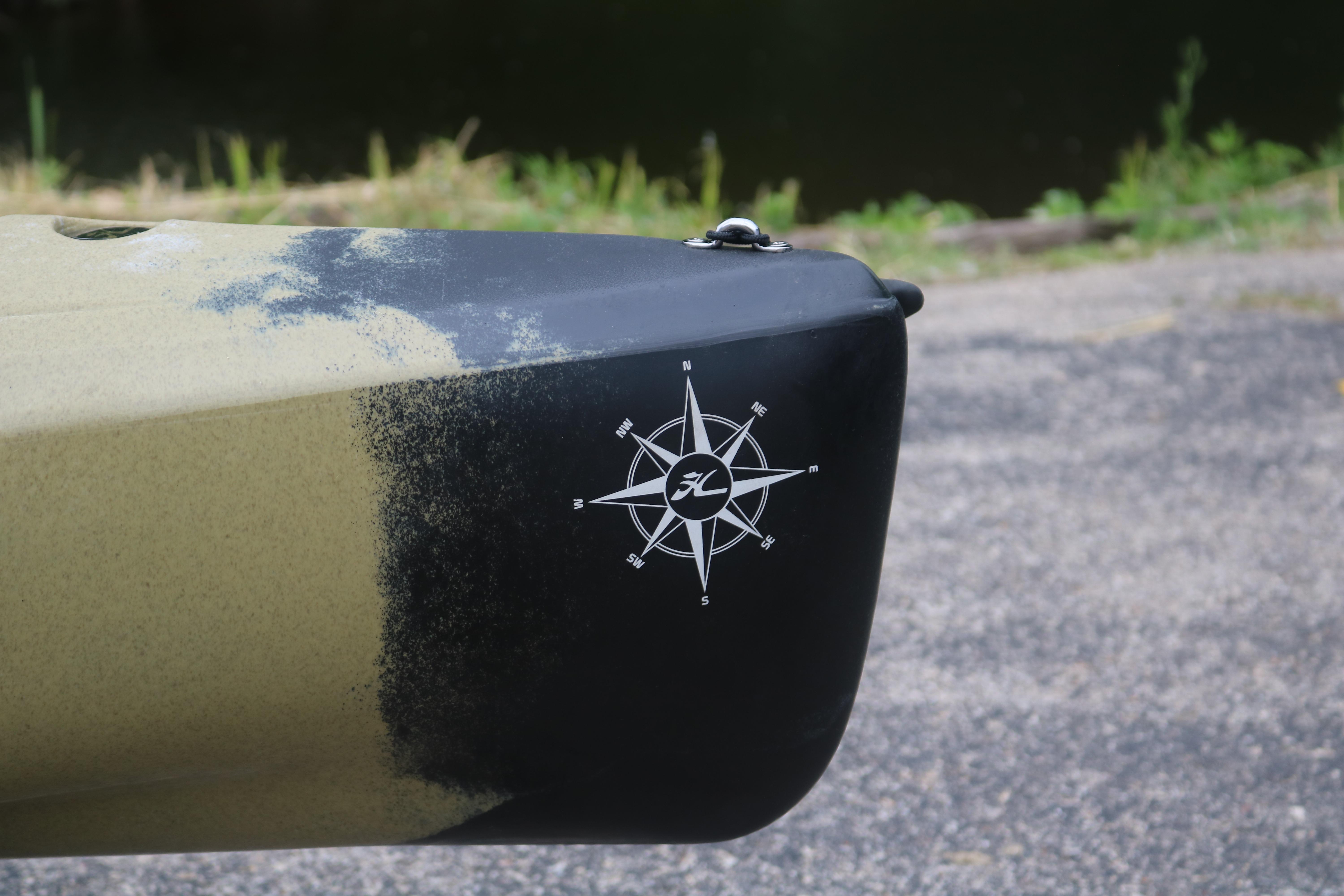 Close-up of 2023 Hobie Mirage Compass kayak bow with compass logo.