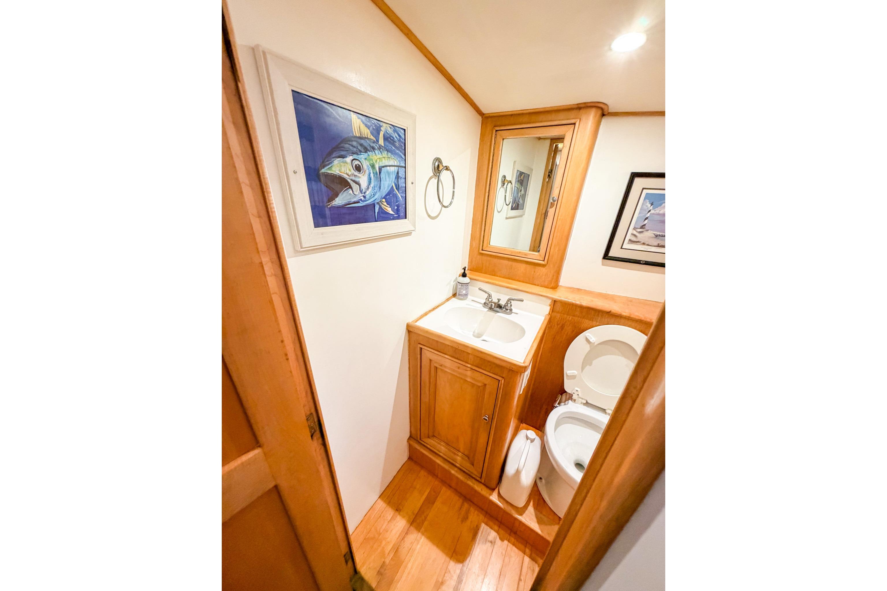 1998 Blackwell Custom Carolina Sportfish bathroom with wooden cabinetry and fish artwork.