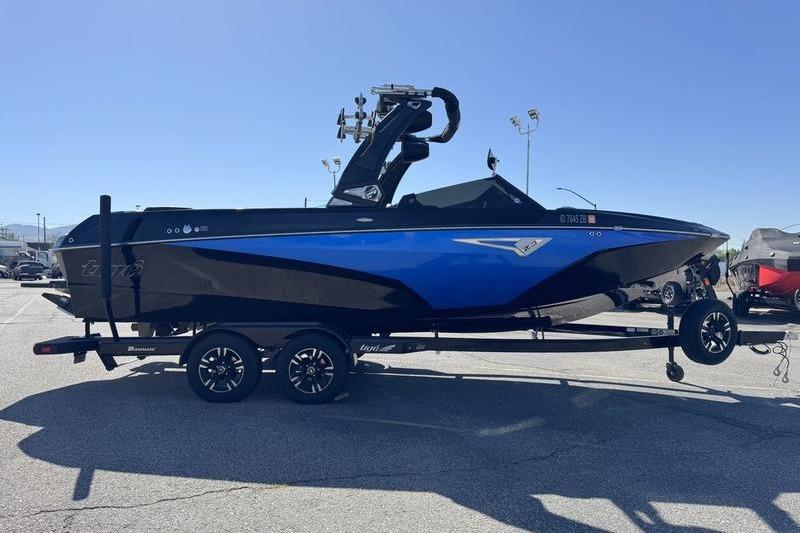 2022 Tigé Z3 boat in blue and black on a trailer in a parking lot.
