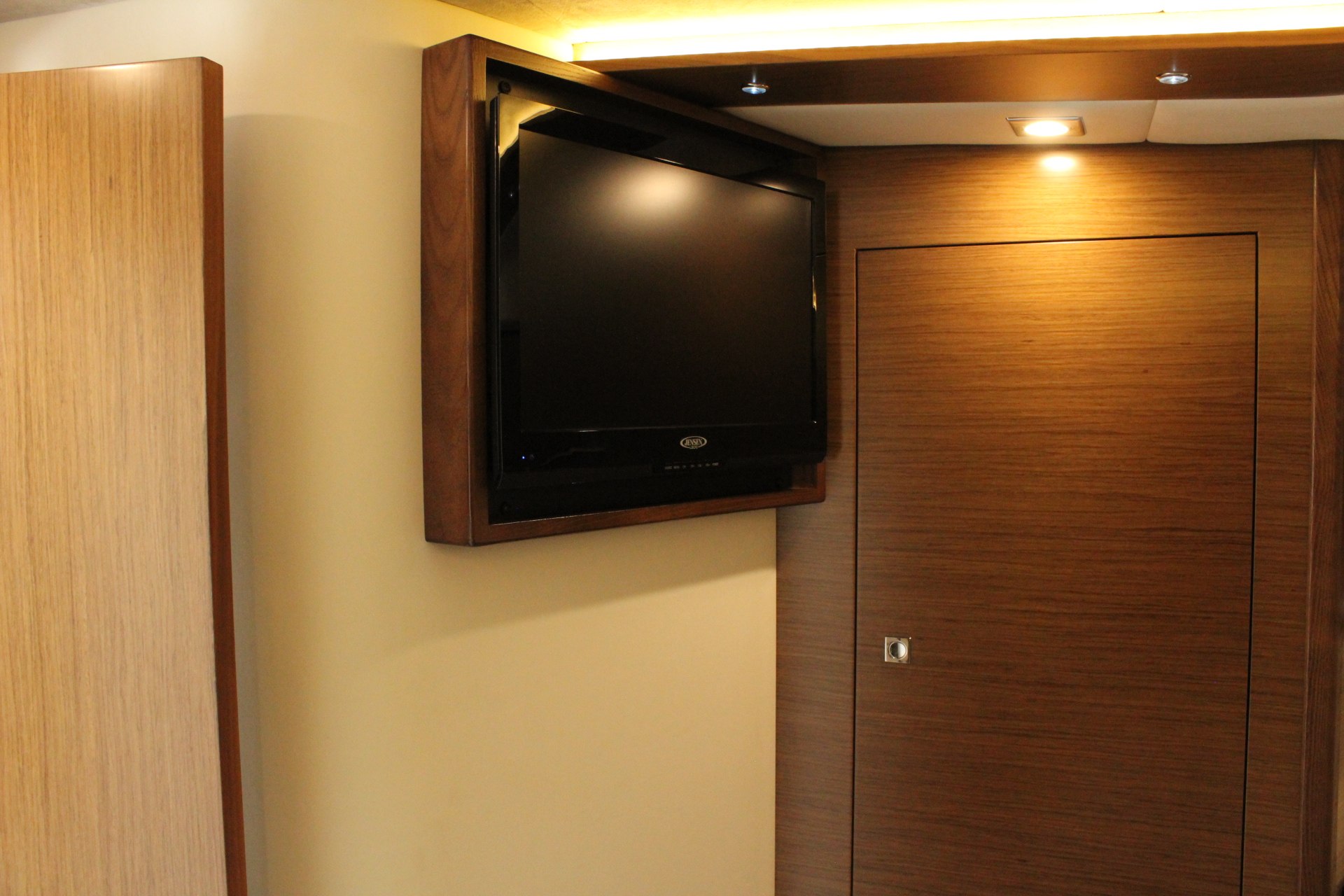Interior of 2014 Cruisers Yachts 45 Cantius with TV and wooden doors.