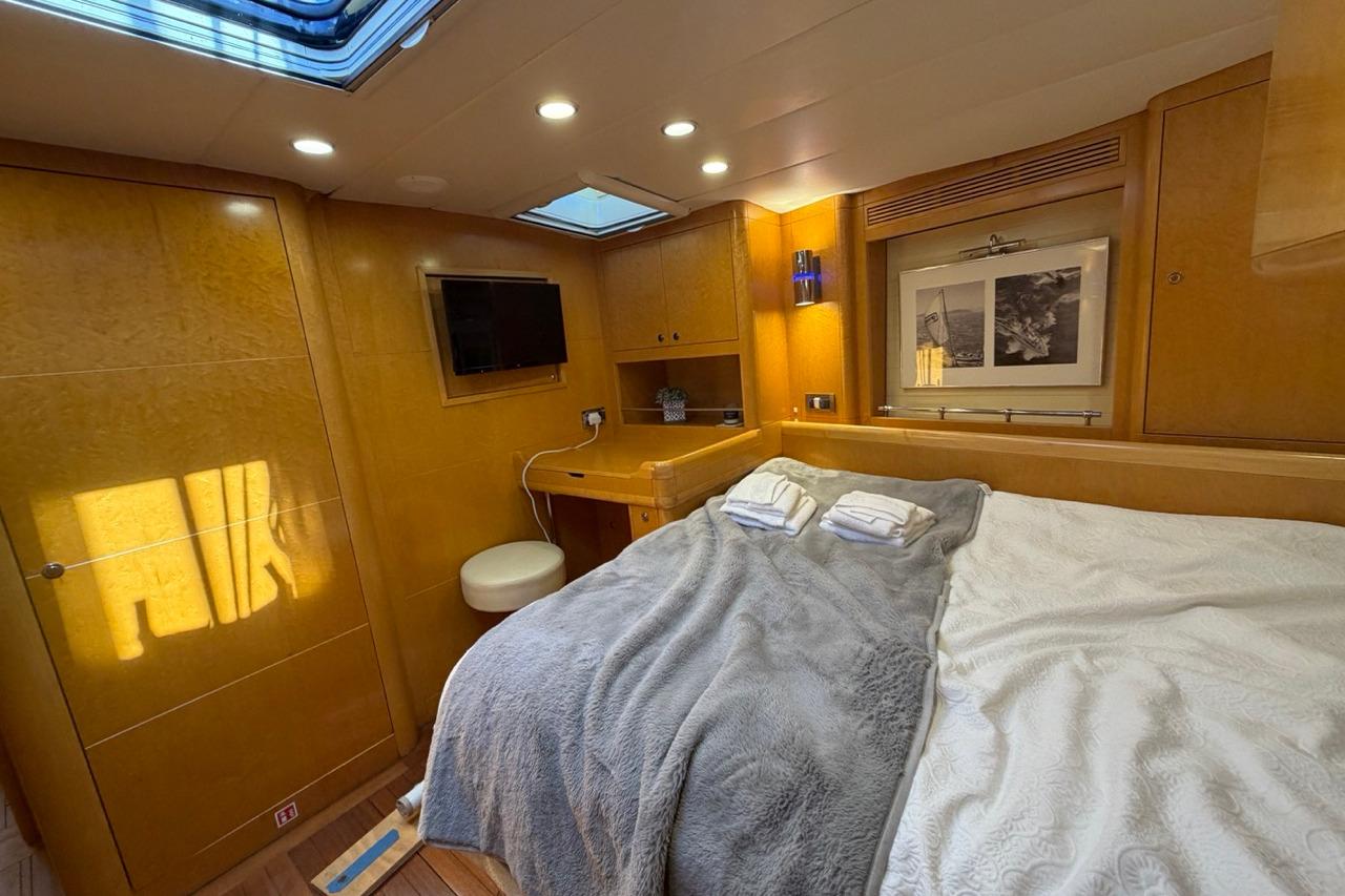 Luxurious cabin interior of 1991 Custom David Thomas Challenge 67 yacht with cozy bedding.