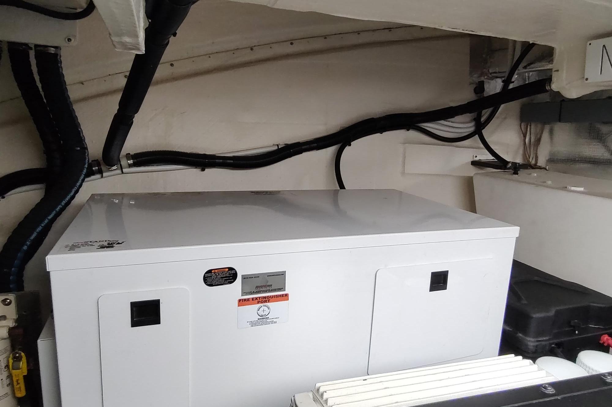 Engine room of 2021 Regal 42 Fly yacht with generator and wiring.