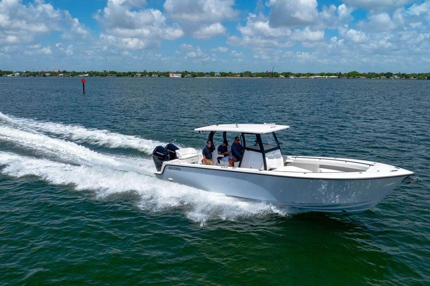 2027 Reef Runner 340 boat cruising on open water under a partly cloudy sky.