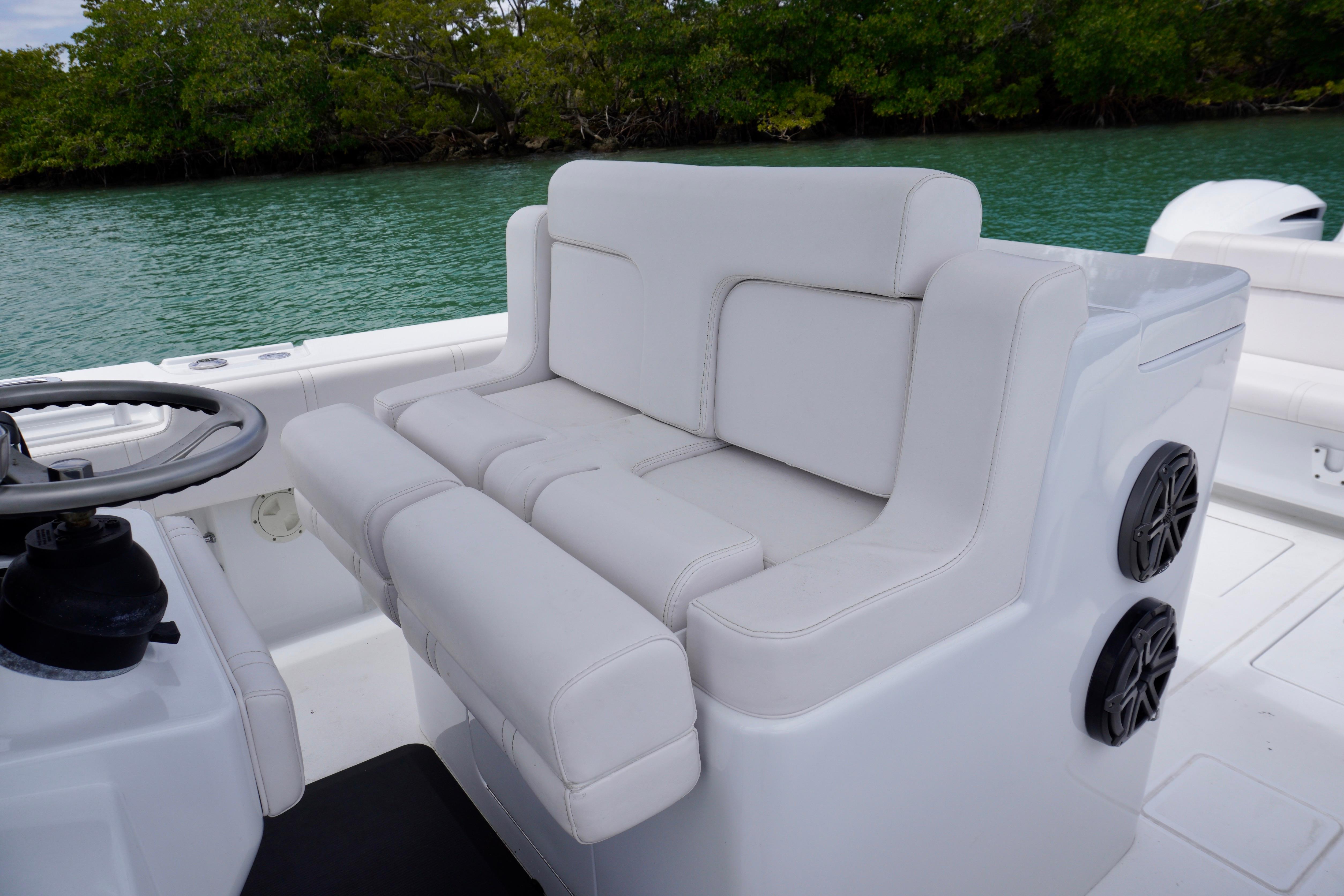 Contender 35 LS 2013 boat interior with white cushioned seating and steering wheel.