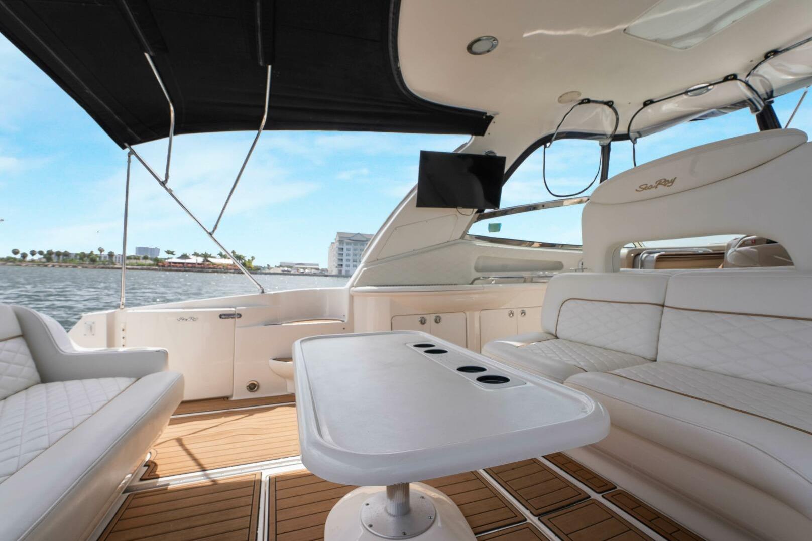 Luxurious 2003 Sea Ray Sundancer 460 yacht interior with elegant seating and scenic waterfront view.