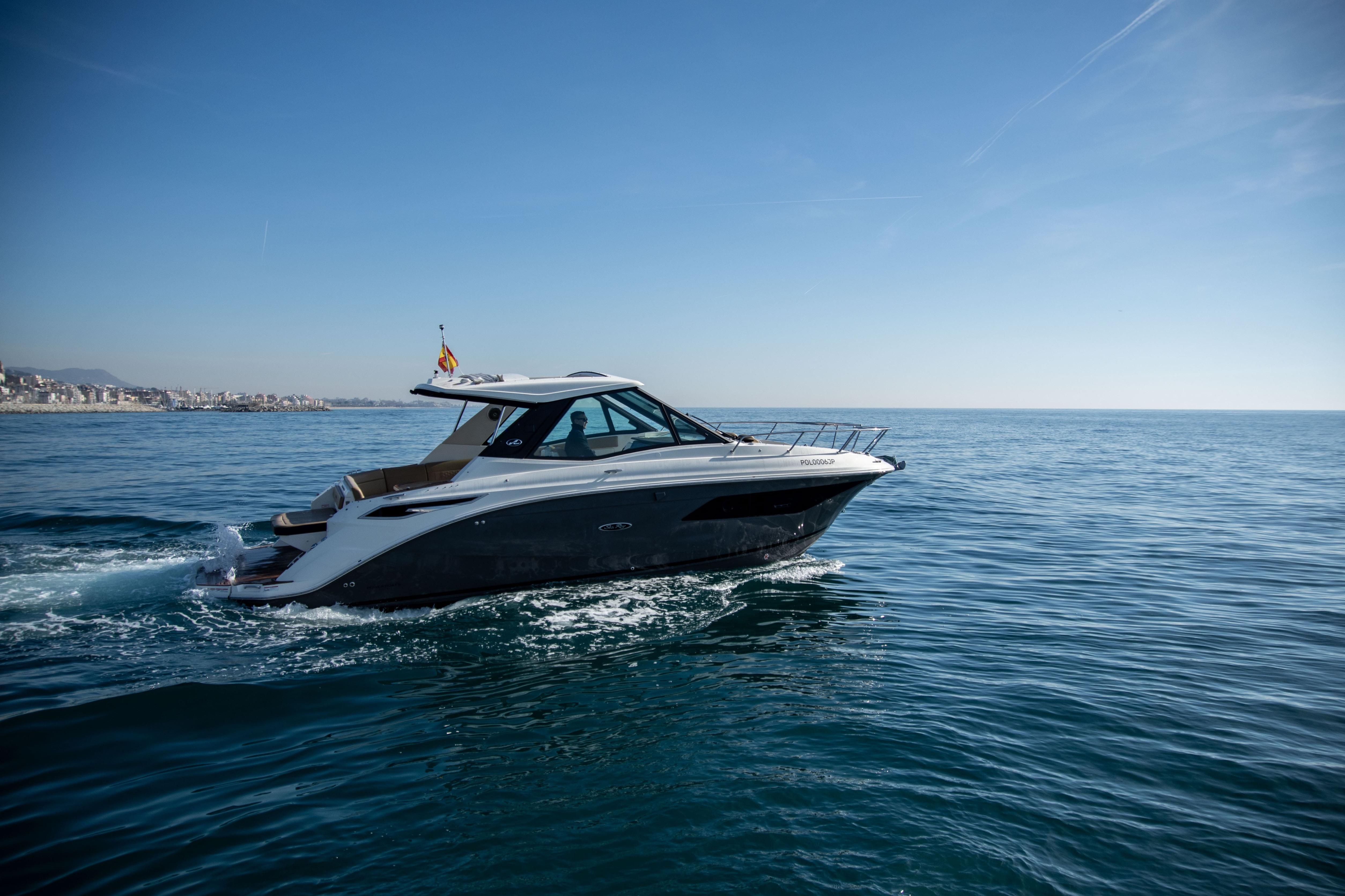 2022 Sea Ray Sundancer 320 cruising on open water under clear blue skies.