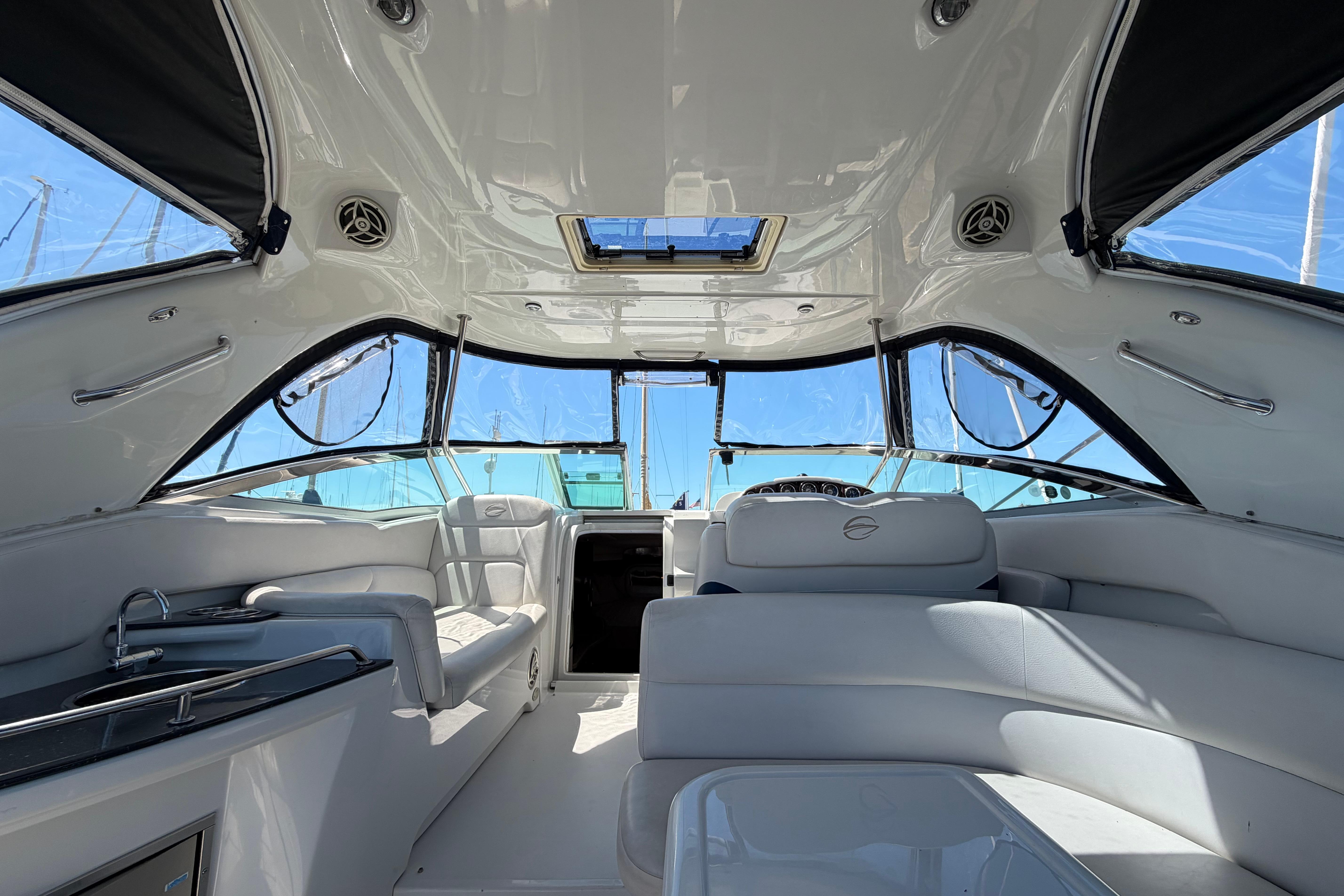Interior of a 2008 Crownline 340 CR boat with sleek white seating and modern design.