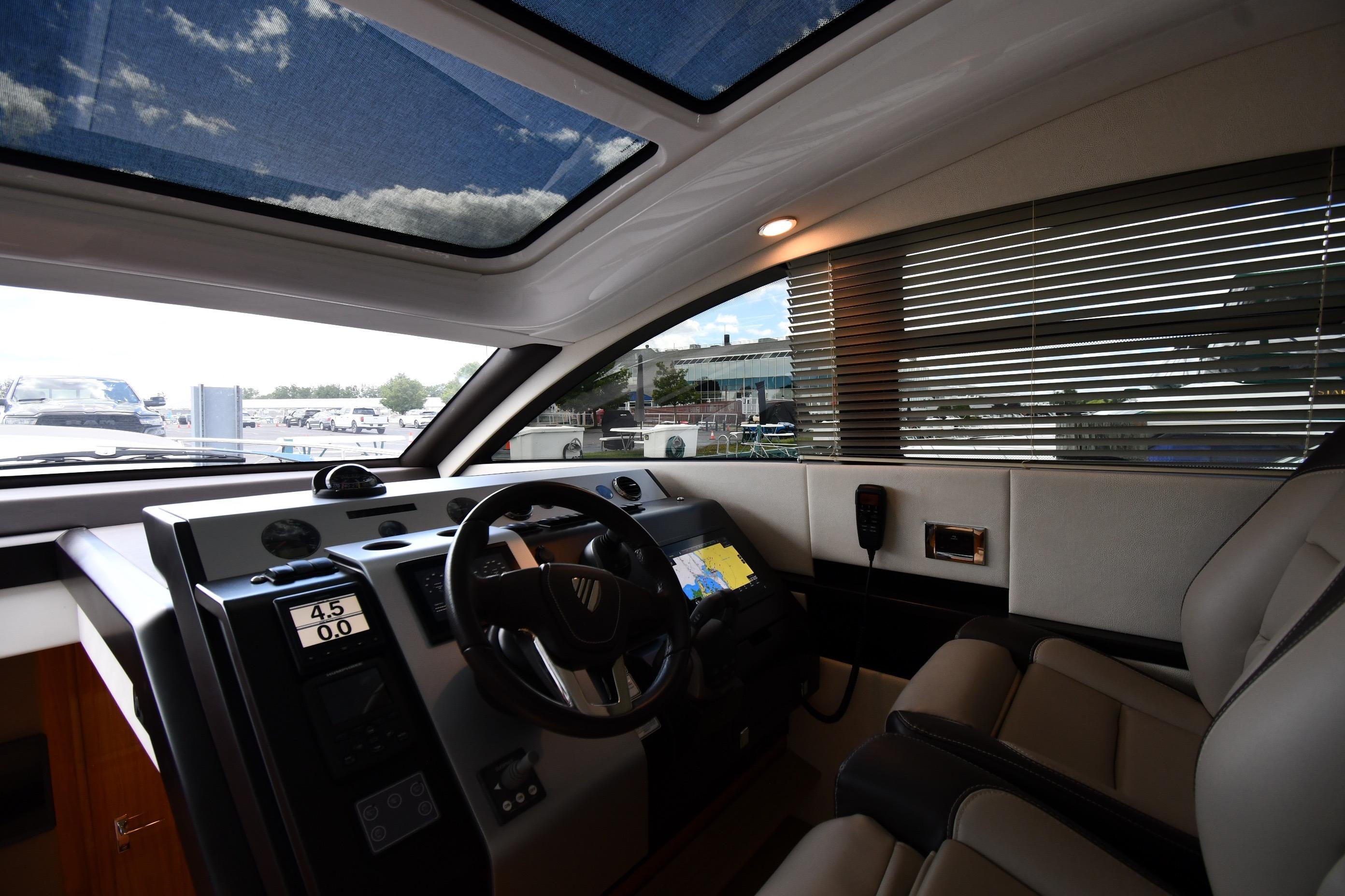 Interior cockpit of 2024 Fairline G50 Targa yacht with modern controls and panoramic windows.
