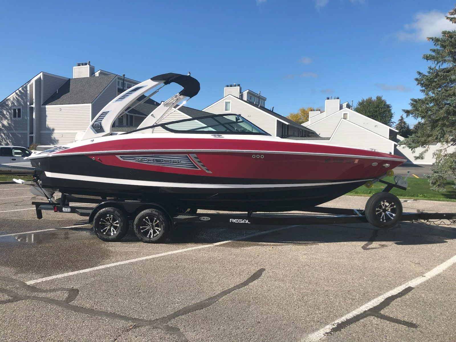 2019 Regal 25 RX Surf boat parked on trailer outdoors.