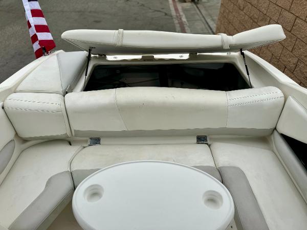 2006 Larson LXi 248 boat interior with white seating and table.