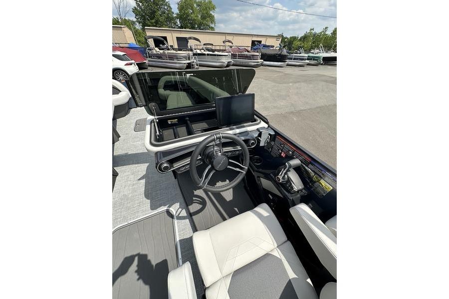 Interior view of 2026 Flamingo Rove 24' boat cockpit with steering wheel and dashboard.