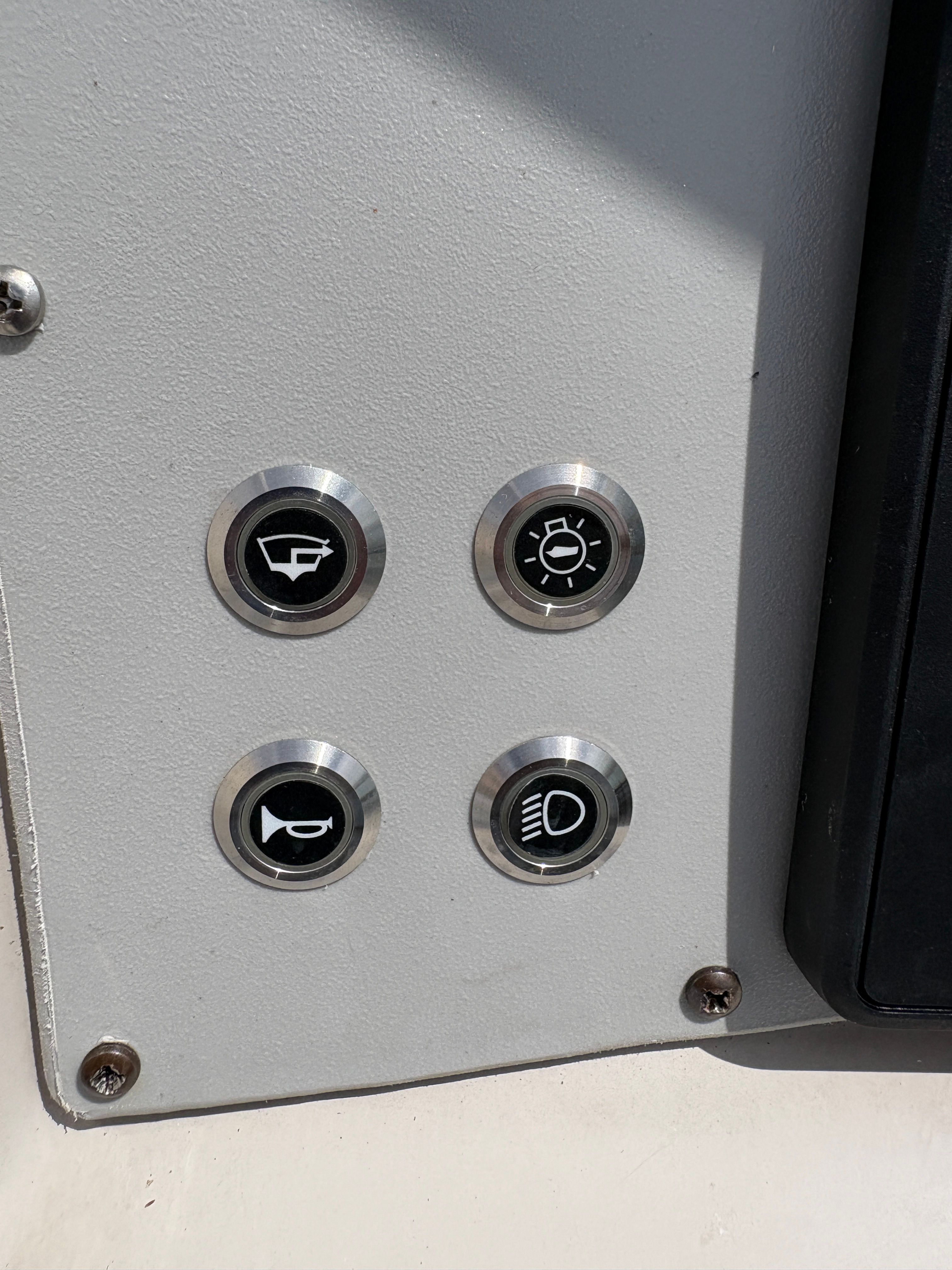 Control panel with four buttons on a 2009 Hurricane SUN DECK 260 boat.