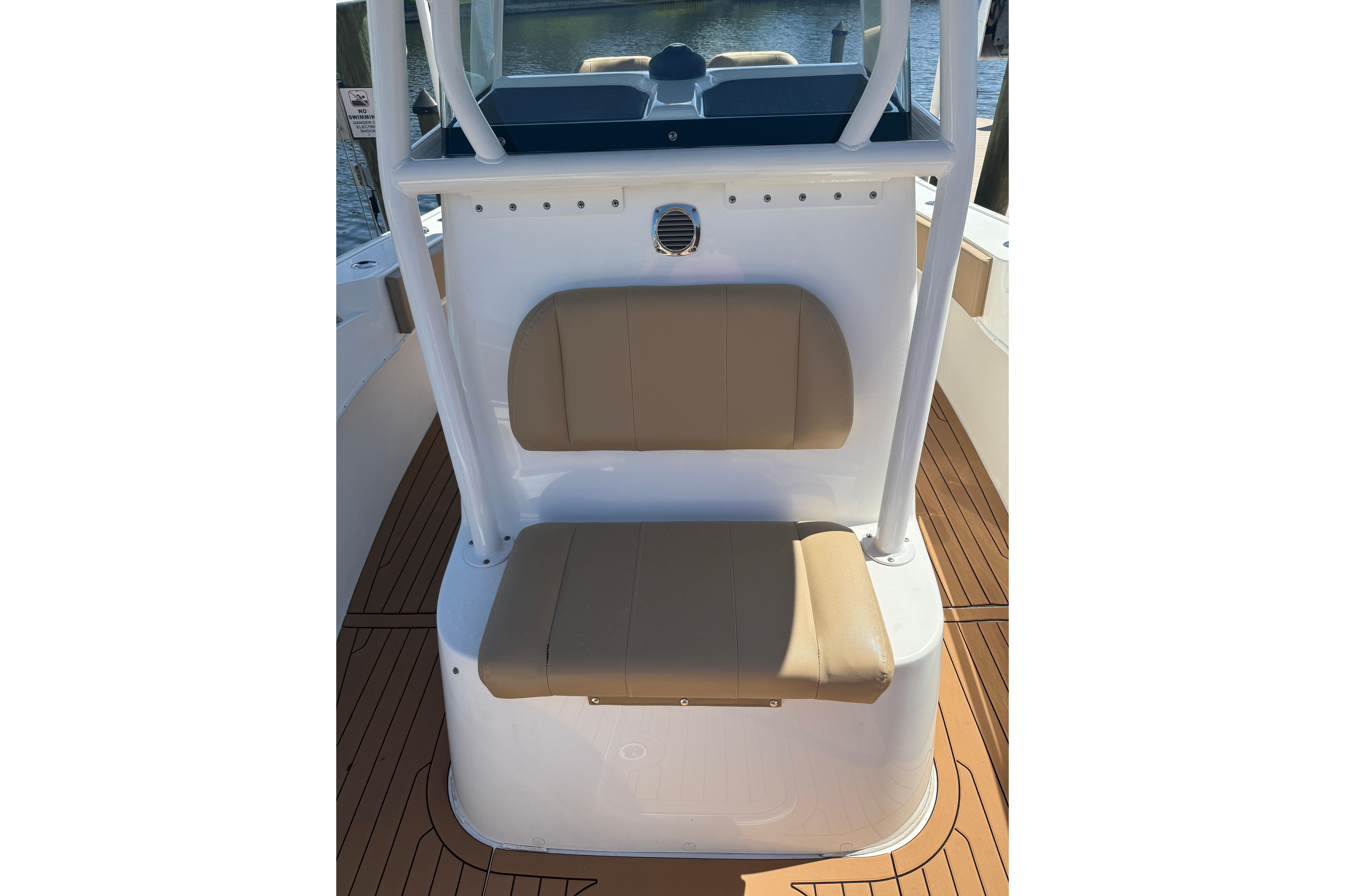 2019 Cape Horn 27XS boat interior with tan seating and wood-style flooring.