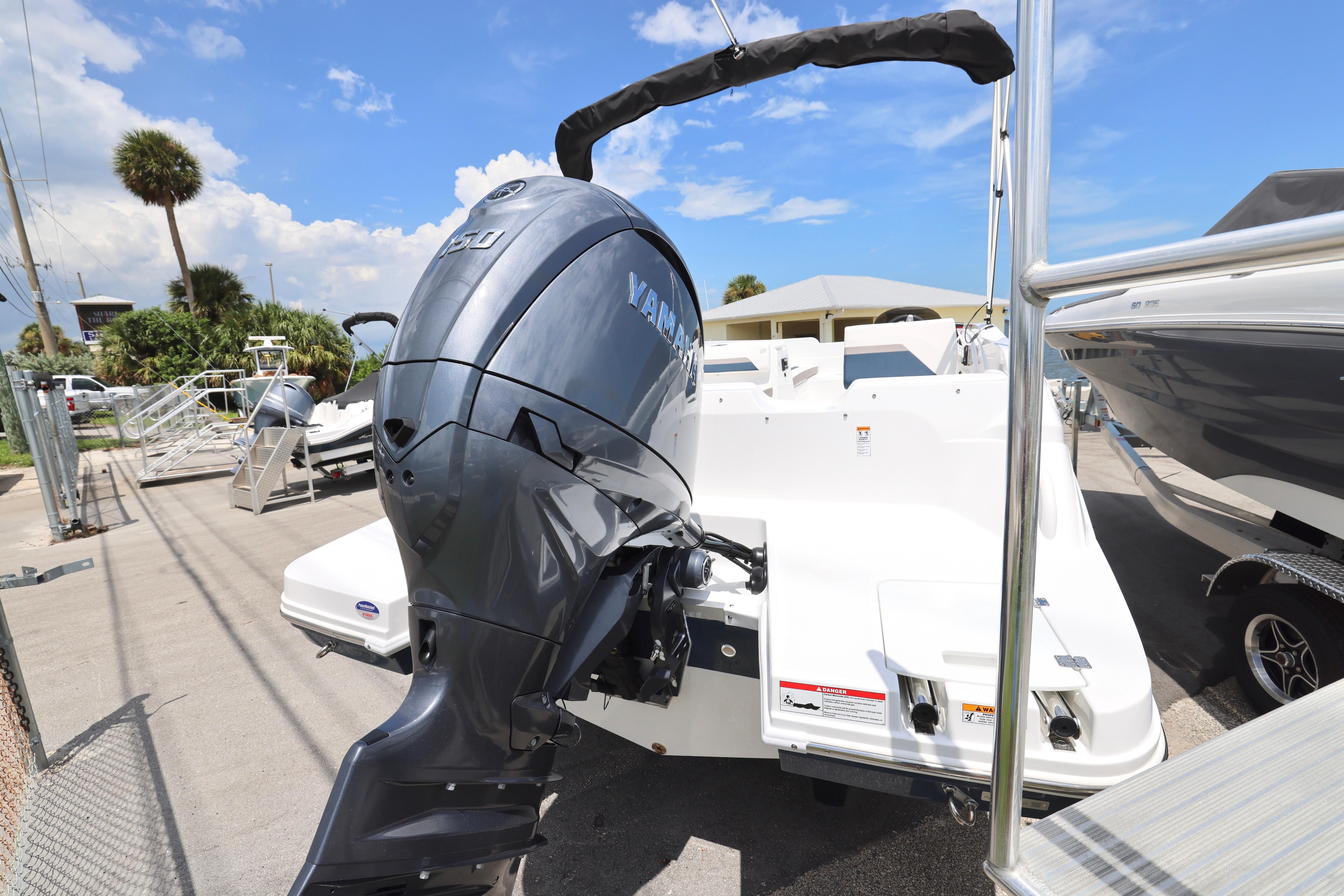 2026 Hurricane SunDeck Sport 205 OB with Yamaha outboard motor, parked outdoors.
