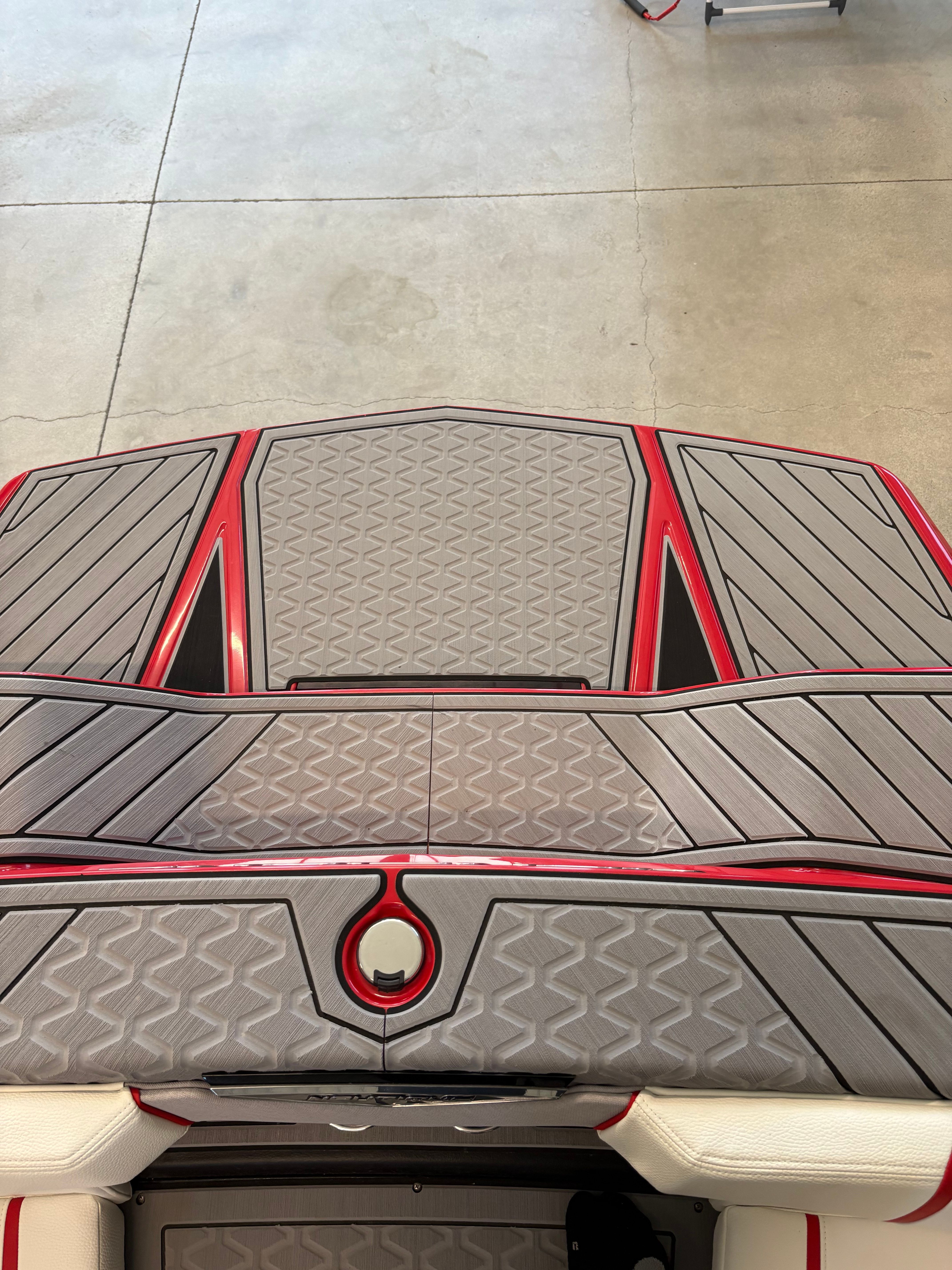 The image shows the deck of a 2023 Nautique Ski Nautique boat with gray and red accents.