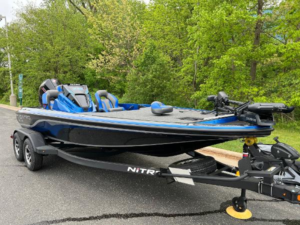 2025 Nitro Z19 Pro boat on trailer, parked near lush green trees.