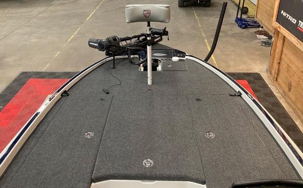 2025 Triton 20XP boat deck with trolling motor and seat in a garage setting.