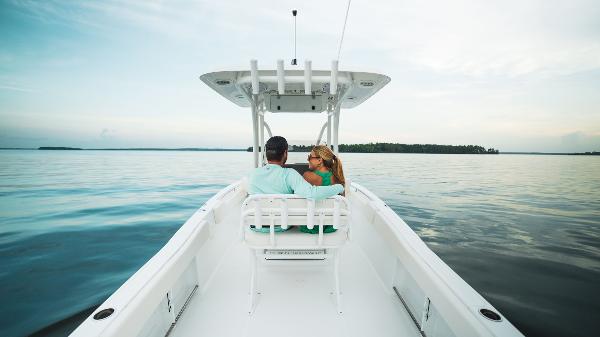 Couple enjoying a serene ride on a 2024 Sea Hunt Ultra 234 boat.