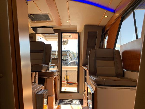 Interior of 2021 Cutwater C-32 CB boat with modern seating and natural lighting.