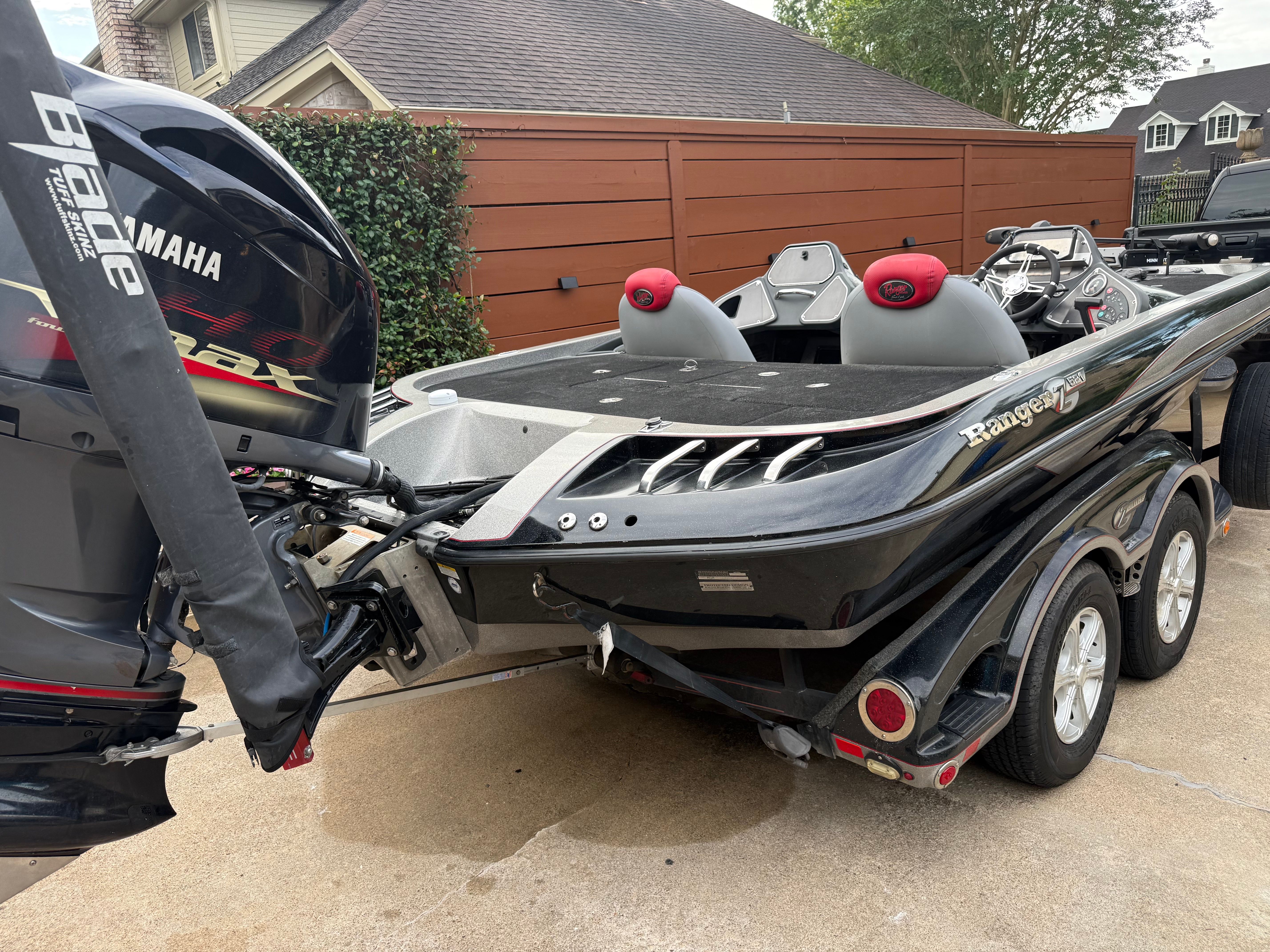 A 2011 Ranger Z521 Comanche on a trailer in a driveway.