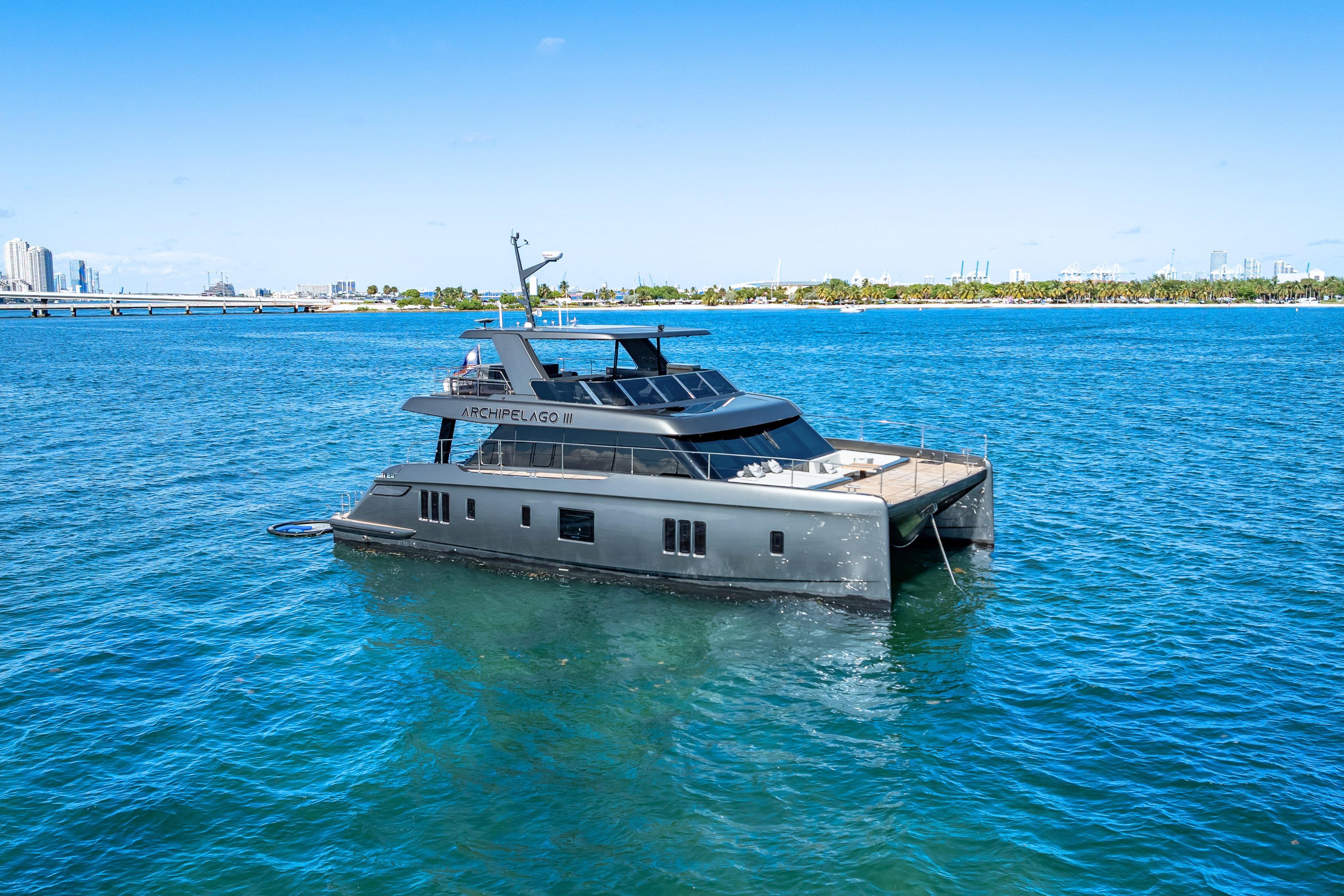 2026 Sunreef 60 Power yacht on blue ocean near city skyline.