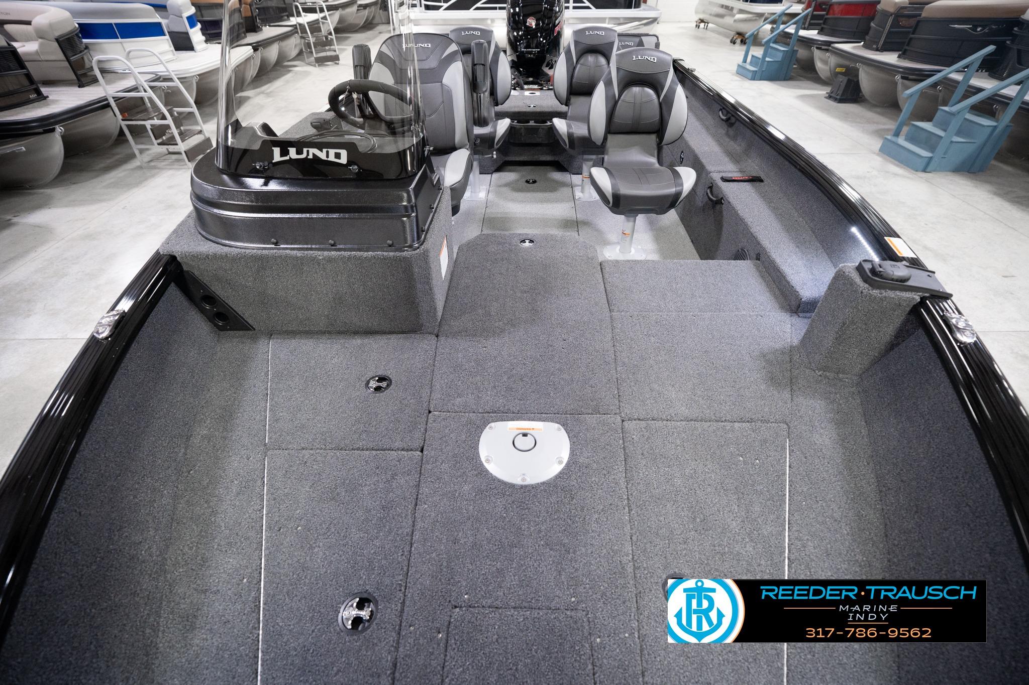 2026 Lund 1775 Impact XS SS boat interior with gray seating and carpeted flooring.