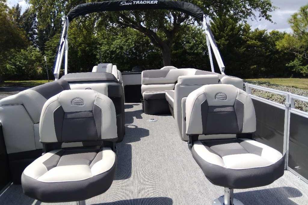 2026 Sun Tracker Fishin' Barge 22 DLX pontoon boat with comfortable seating and spacious deck.