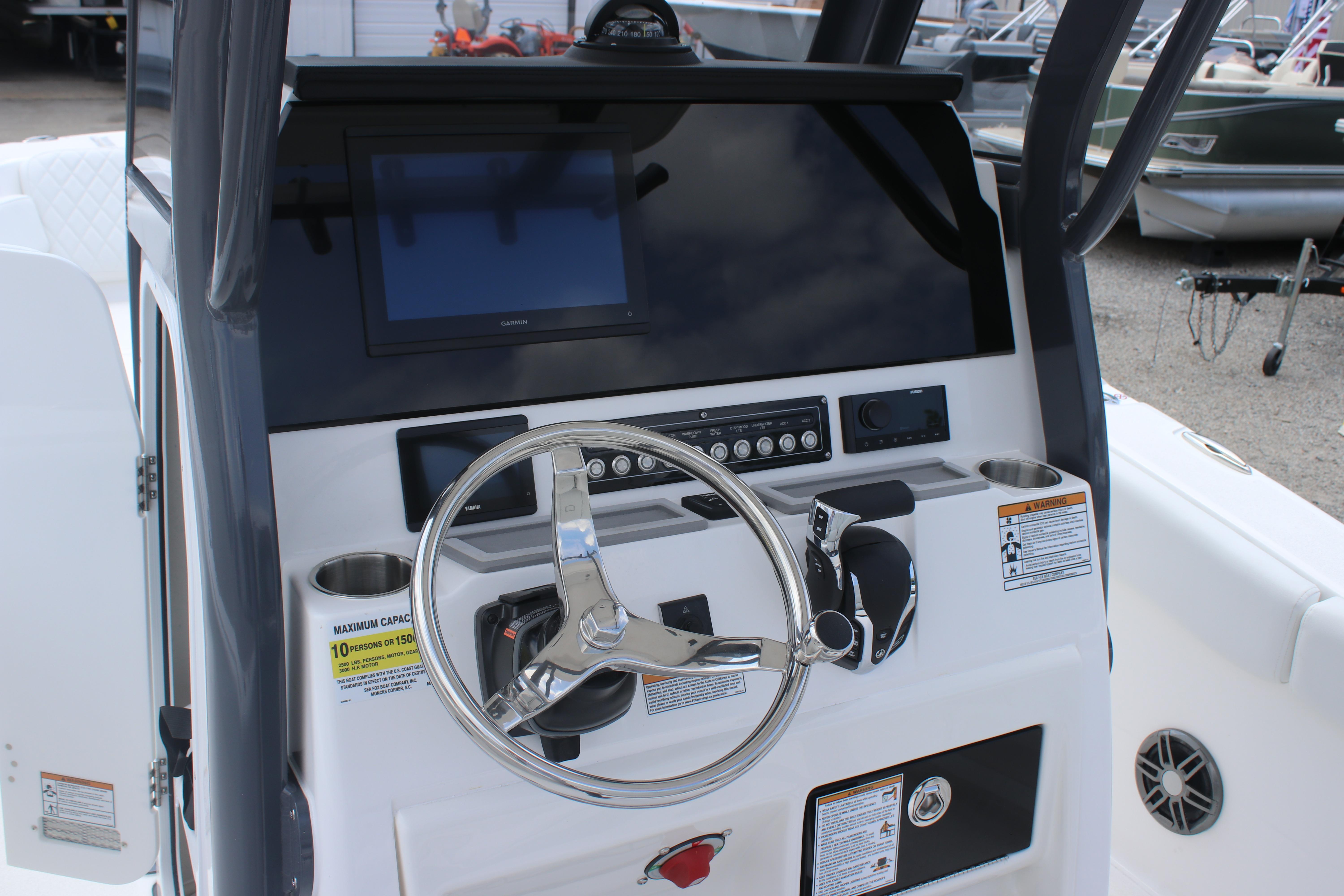 2026 Sea Fox 248 Commander boat dashboard with steering wheel and electronic display.