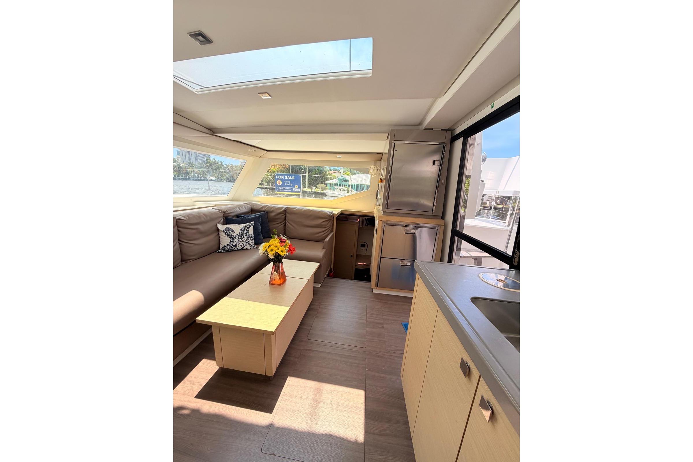 Interior of 2018 Fountaine Pajot Lucia 40 catamaran with modern kitchen and cozy seating area.