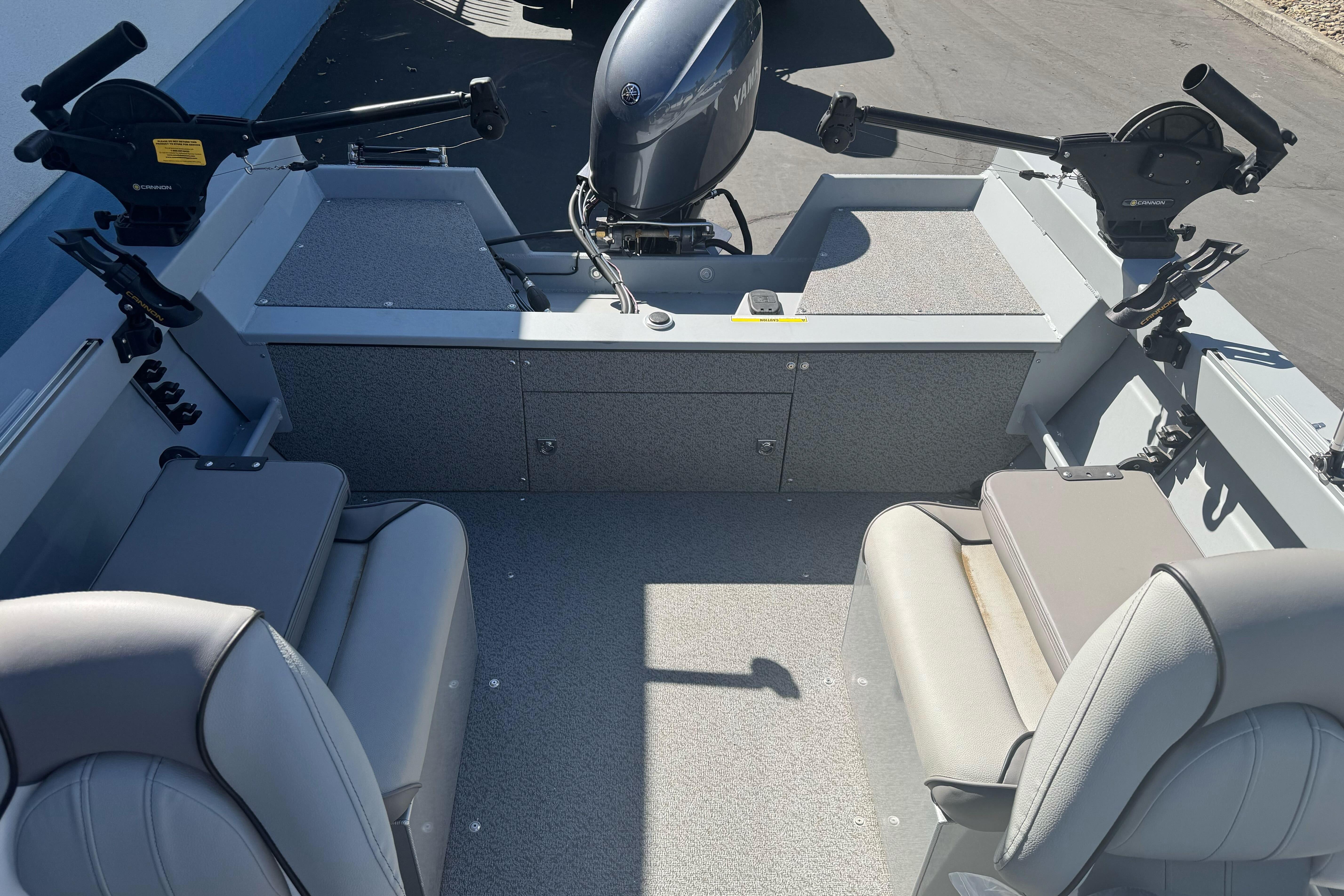 2026 KingFisher 16 Falcon boat interior with seating and motor, featuring modern design.