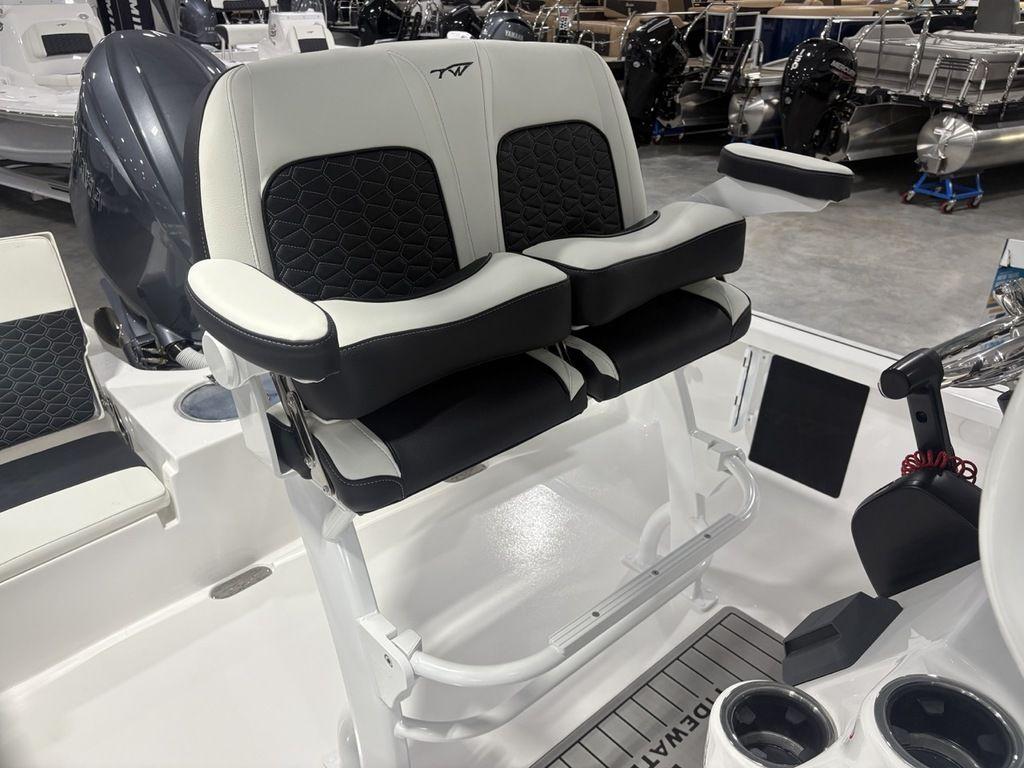 2026 Tidewater 2110 BM boat seating with dual cushioned seats and armrests in a showroom.